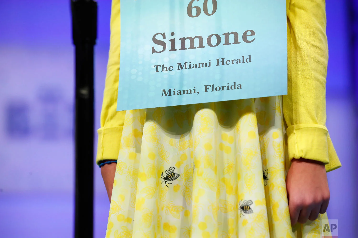 Simone Kaplan, 12, from Davie, Fla., wears a dress with bees on it during the 2nd Round of the Scripps National Spelling Bee, Tuesday, May 29, 2018, in Oxon Hill, Md. (AP Photo/Alex Brandon)