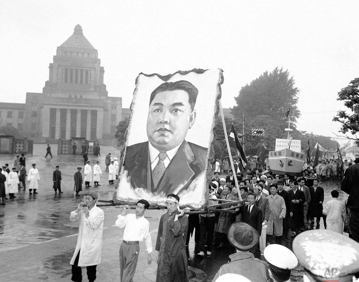 North Korean demonstrators carry a portrait of their country's Communist Prime Minister, Kim Il Sung, in front of the Japanese National Diet (parliament) building in Tokyo during May Day festivities on May 2, 1959. (AP Photo)