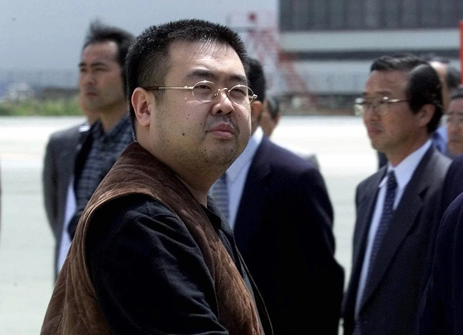 Kim Jong Nam, the eldest son of North Korean leader Kim Jong Il, looks back at a group of photographers before boarding a plane to Beijing at Narita international airport near Tokyo, on May 4, 2001. Kim was fatally poisoned at Kuala Lumpur's airport on Feb. 13, 2017, while traveling under a pseudonym. (AP Photo/Shizuo Kambayashi)