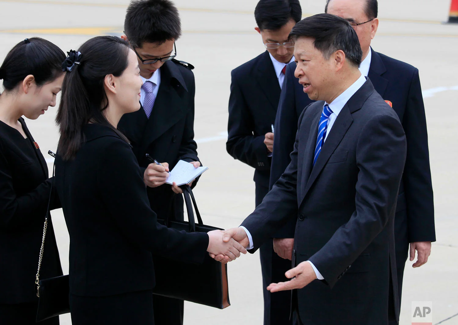 Song Tao, right, head of the Chinese Communist Party Central Committee's international department, shakes hands with Kim Yo Jong, the sister of North Korean leader Kim Jong Un, as a Chinese art troupe led by Song arrives at Pyongyang Airport in North Korea on April 13, 2018. (AP Photo/Jon Chol Jin) 