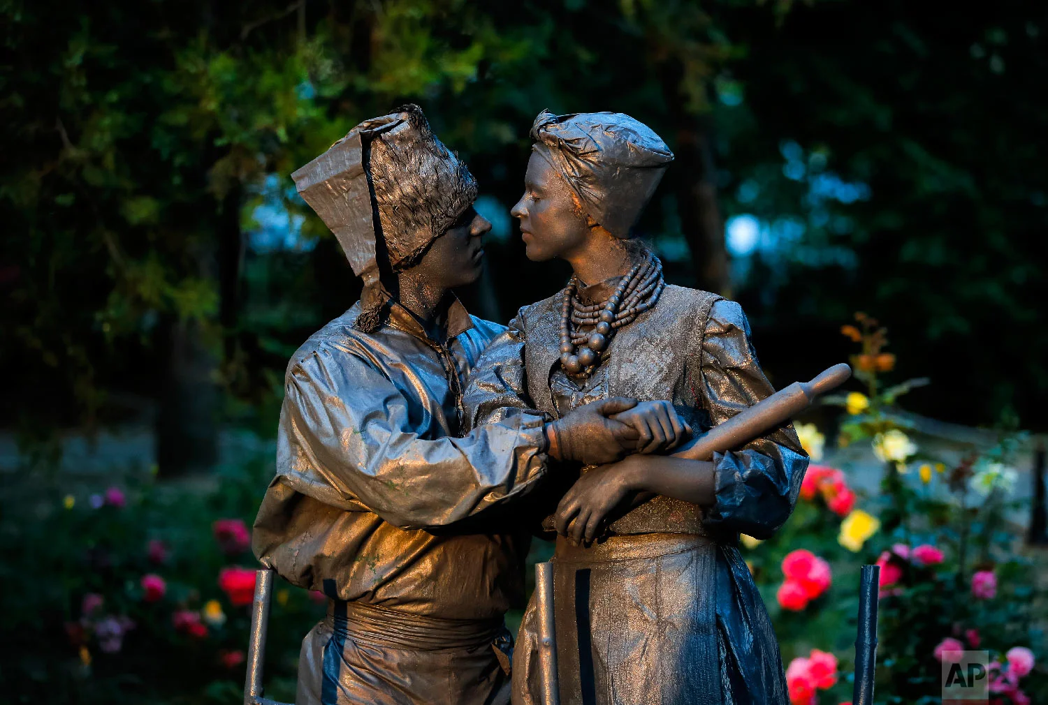 Artists of Ukraine's Artel Myth theatre perform "A day in the life of Ukrainians" at the Living Statues International Festival, in Bucharest, Romania on Thursday, May 24, 2018. (AP Photo/Vadim Ghirda)