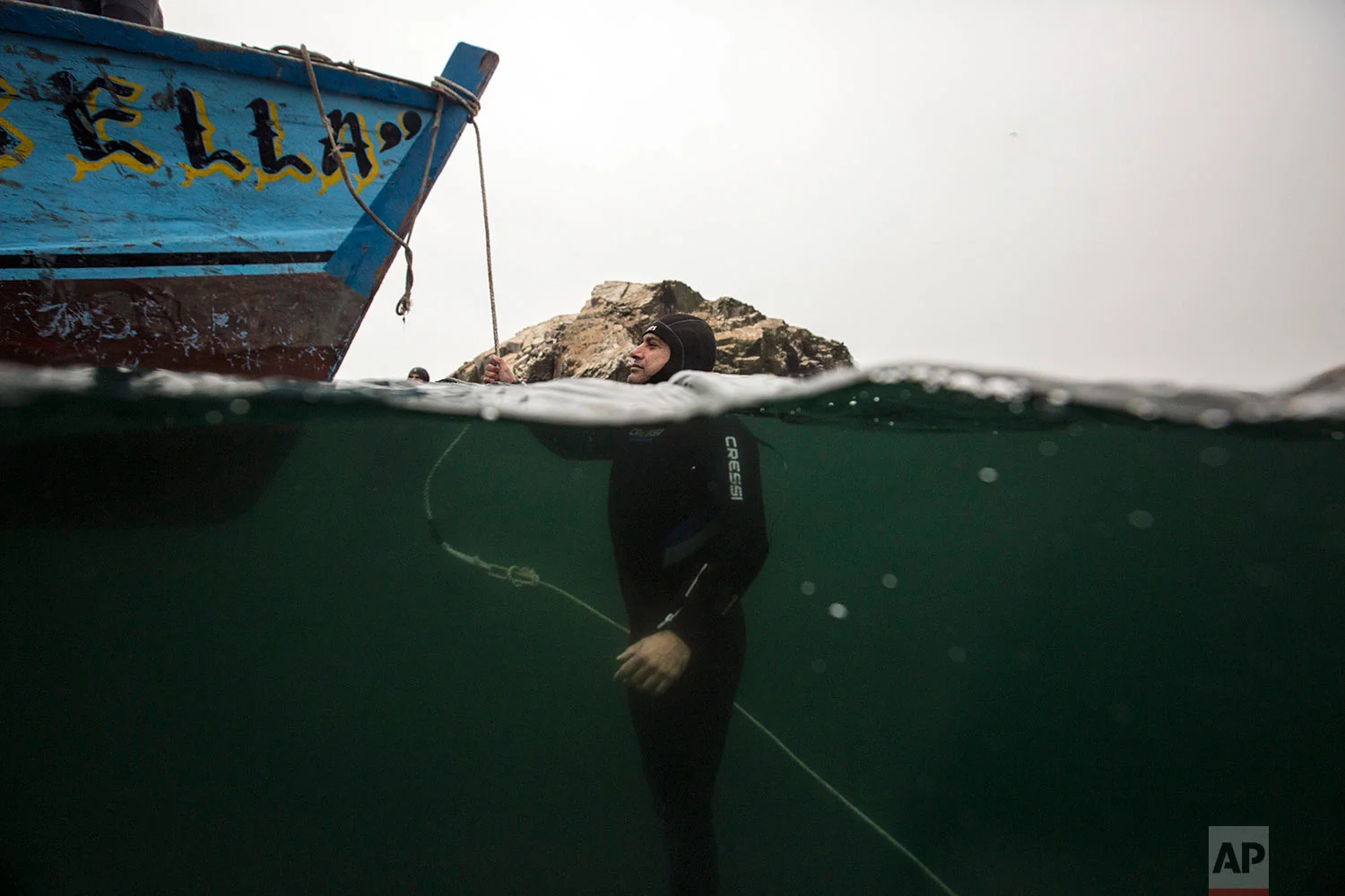 A diver stays afloat in the Pacific Ocean at the end of an exploration excursion of a sunken ship close to the Ancon coast, near Lima, Peru, Sunday, May 27, 2018. The El Ferrol, an old cargo ship, ran aground in 2005 and sank in 2007. (AP Photo/Rodrigo Abd)
