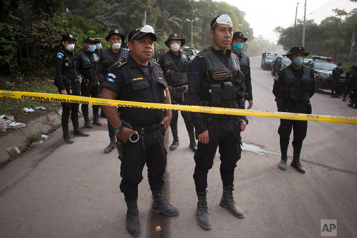 Police officers secure the rescue area near Volcan de Fuego, or Volcano of Fire in Escuintla, Guatemala, Tuesday, June 5, 2018. (AP Photo/Luis Soto)