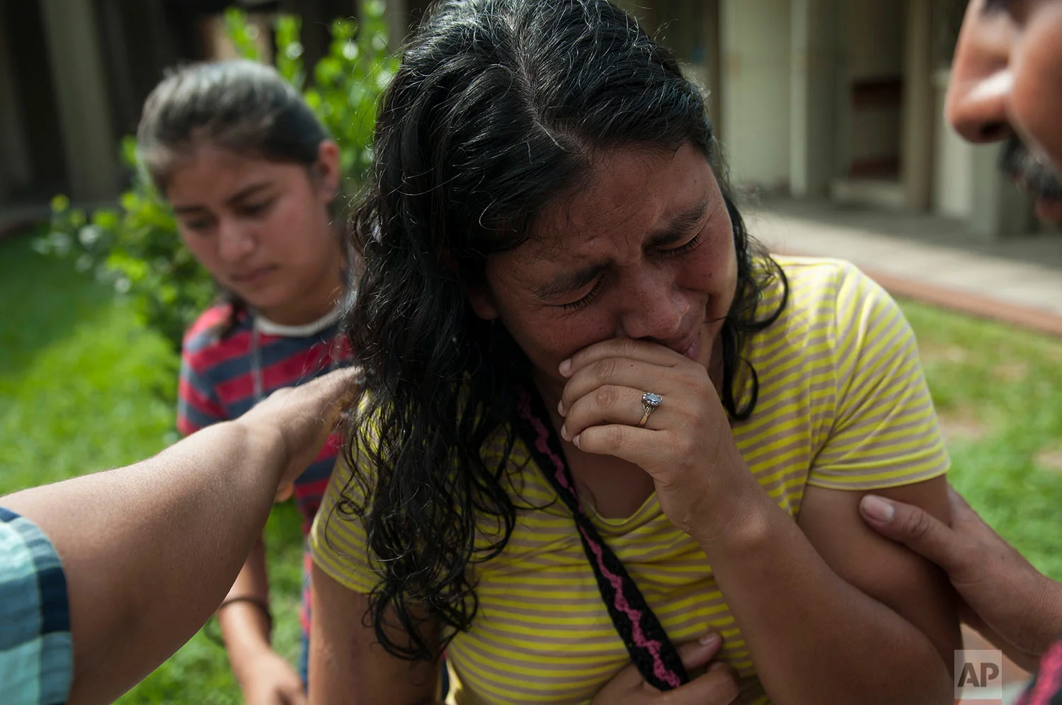 Lilian Hernandez cries as she is comforted by her husband at the Mormon church that has been enabled as a shelter near Escuintla, Guatemala, Tuesday, June 5, 2018. Hernandez lost 36 family members in all, missing and presumed dead in the town of San Miguel Los Lotes after the fiery volcanic eruption of the Volcan de Fuego, or "Volcano of Fire, in south-central Guatemala. (AP Photo/Oliver de Ros)