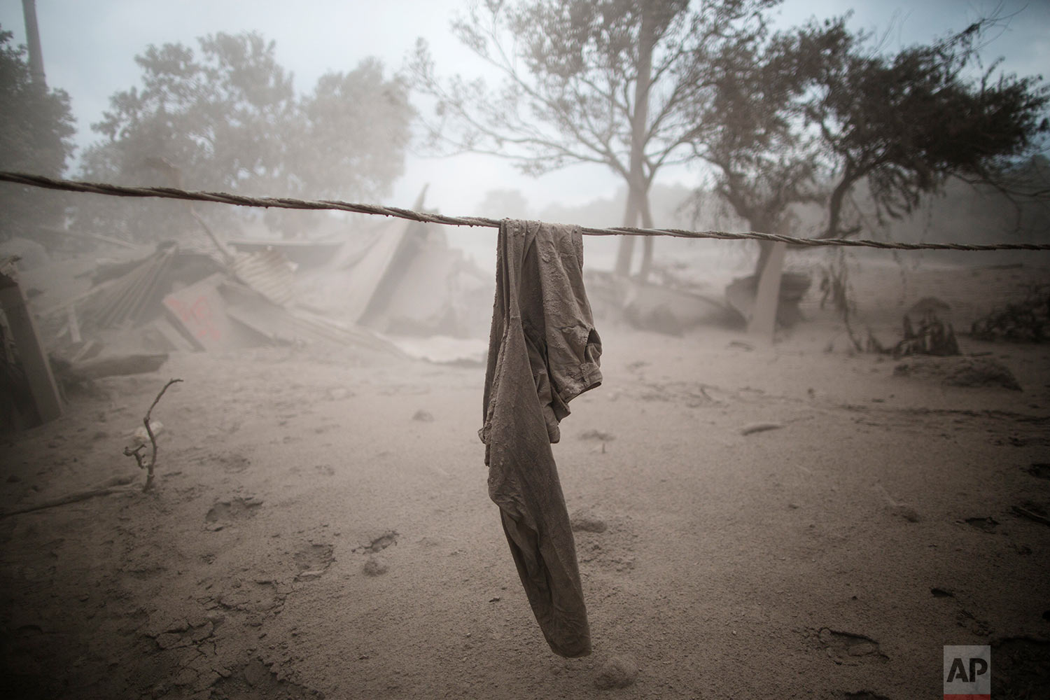 A pair of pants hang near a destroyed home in the disaster zone covered in volcanic ash near the Volcan de Fuego, or "Volcano of Fire," in the El Rodeo hamlet of Escuintla, Guatemala, Tuesday, June 5, 2018. &nbsp;(AP Photo/Rodrigo Abd)