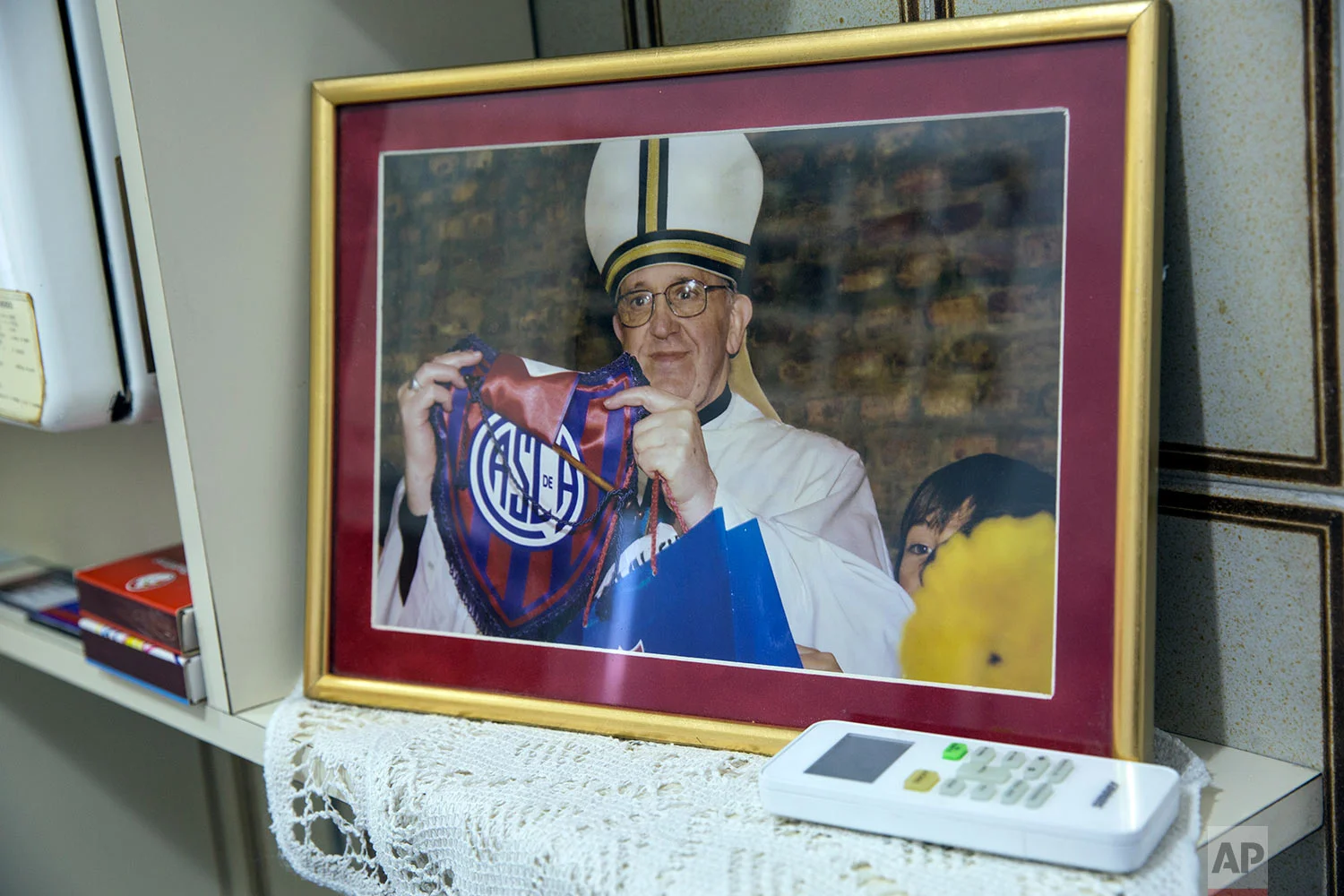  A framed photograph of Pope Francis shows him holding a San Lorenzo soccer logo, on display at the home of soccer fan Josesito Haydossian in Buenos Aires, Argentina, April 14, 2018. (AP Photo/Rodrigo Abd)