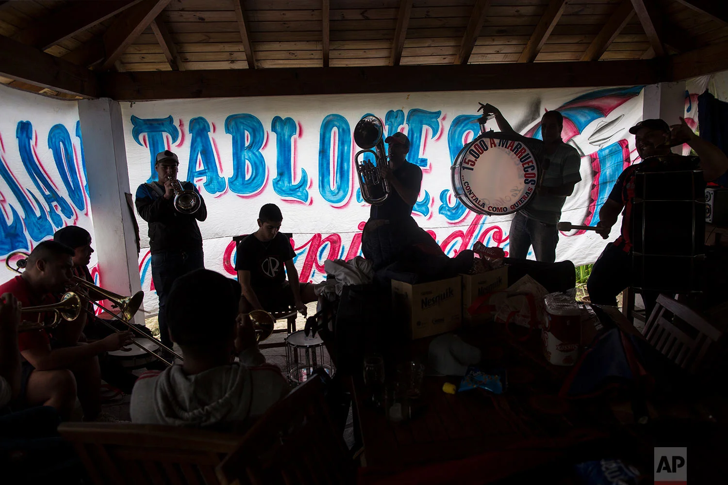 Musicians from the School of Wooden Planks, a name in honor of the wooden bleachers in many stadiums, create new songs for the fans of the San Lorenzo soccer team and Argentina's national team, in Buenos Aires, Argentina, May 1, 2018. (AP Photo/Rodrigo Abd)