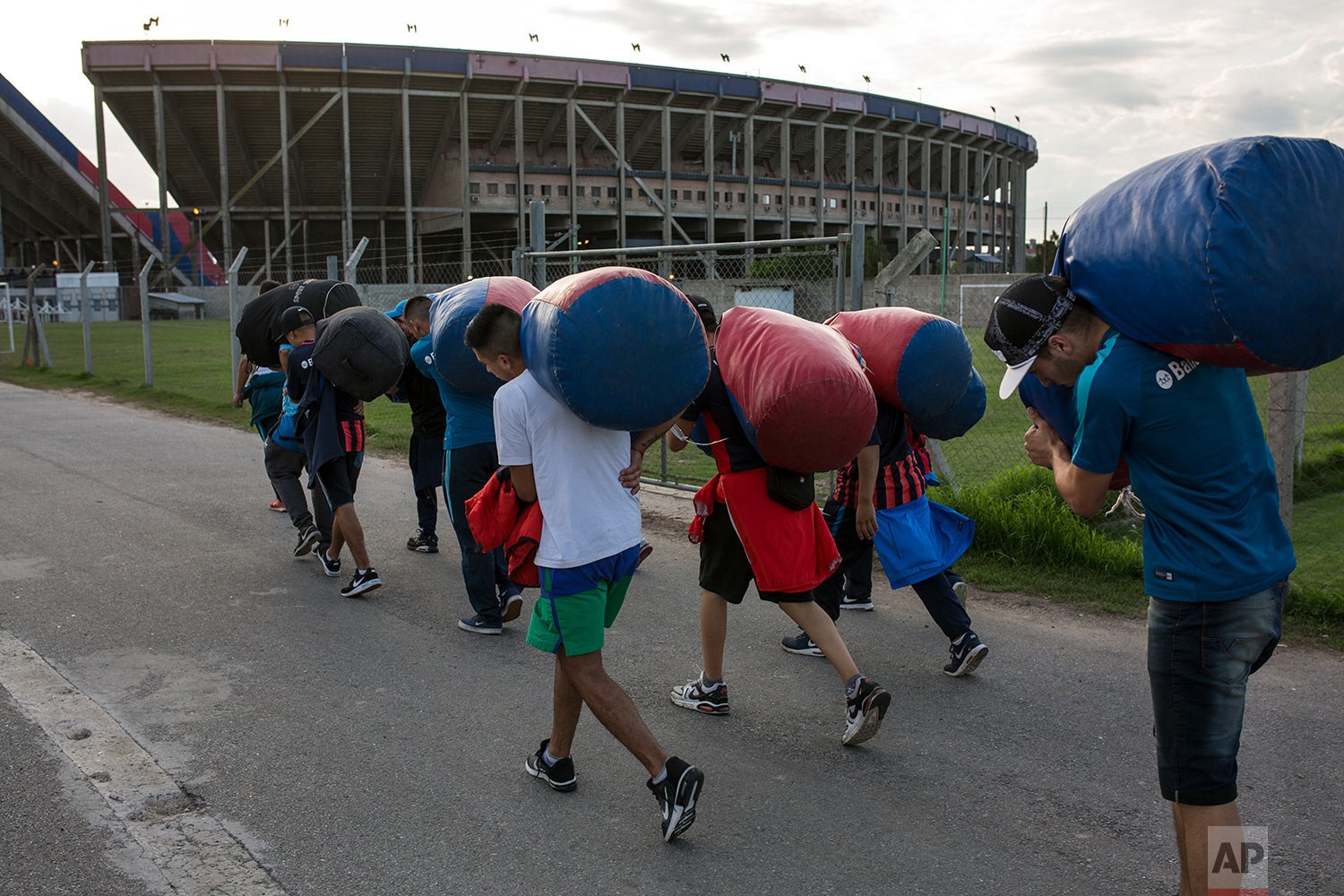  In this April 11, 2018 photo, San Lorenzo soccer fans from the team's most militant fan base, coined "La Butteler," carry bags of team flags to be used in the stands, hours before the start of a match against Brazil's Atletico Mineiro in Buenos Aire
