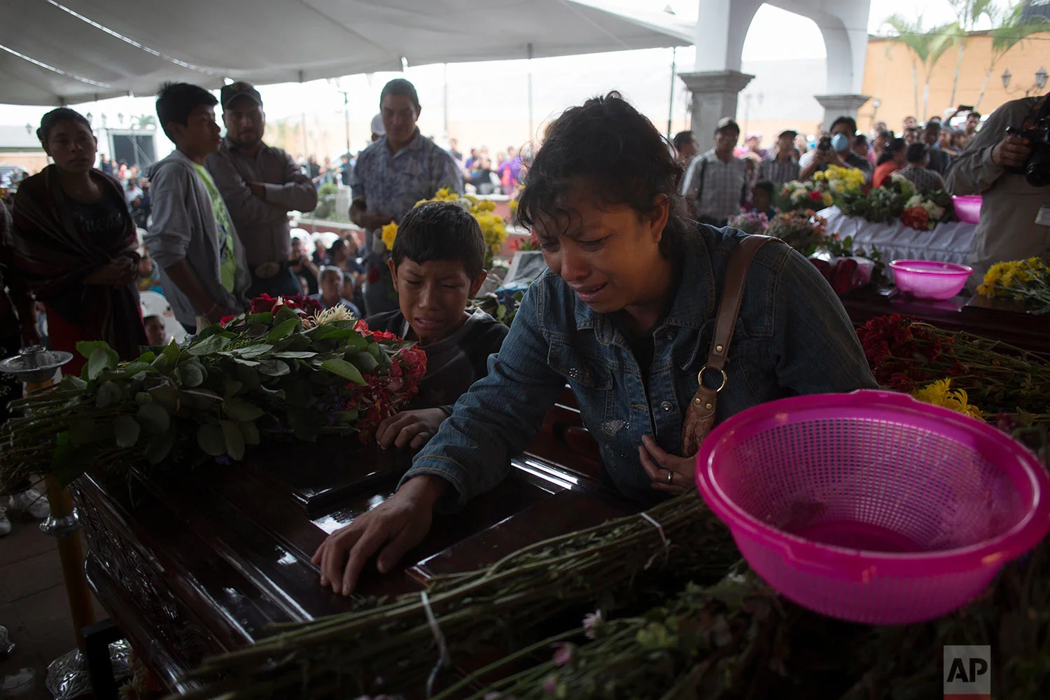 Relatives cry over the coffin of Nery Otoniel Gomez Rivas, 17, whose body was pulled from the volcanic ash during the eruption of the Volcan de Fuego, which in Spanish means Volcano of Fire, during his wake at the main park of the town San Juan Alot…