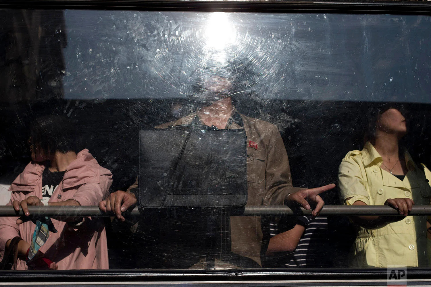 Commuters stand on a bus in Pyongyang, North Korea, on June 24, 2013. (AP Photo/Alexander F. Yuan)