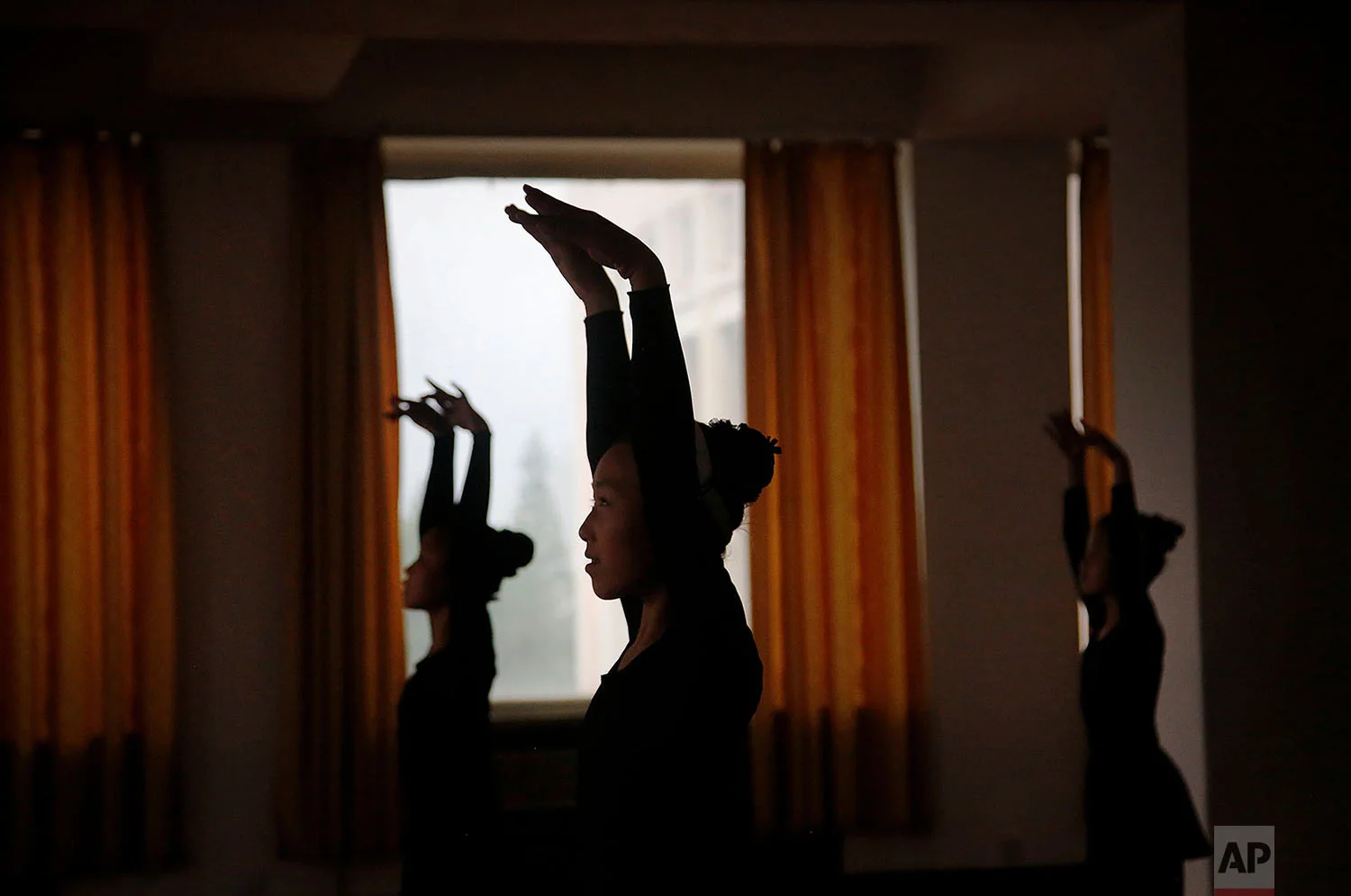 Girls are silhouetted during a dance class at the Mangyongdae Children's Palace in Pyongyang, North Korea, on May 7, 2015. The Children's Palace is a place where talented school children go for extracurricular classes, and is one of the places tourists visit during their stay in Pyongyang. (AP Photo/Wong Maye-E)