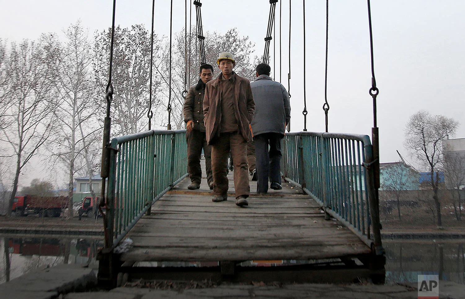 Construction workers walk on a bridge that takes them over the Pothong River in Pyongyang, North Korea, on Nov. 28, 2015. The Pothong River is the second largest river that runs through the North Korean capital. (AP Photo/Wong Maye-E)