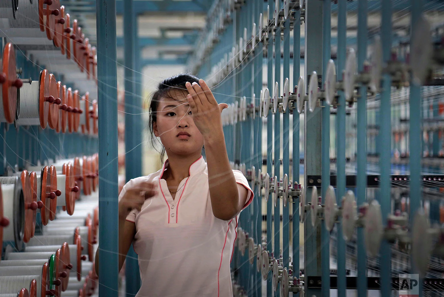 A woman works at the Kim Jong Suk Pyongyang textile factory in Pyongyang, North Korea, on July 31, 2014. (AP Photo/Wong Maye-E)