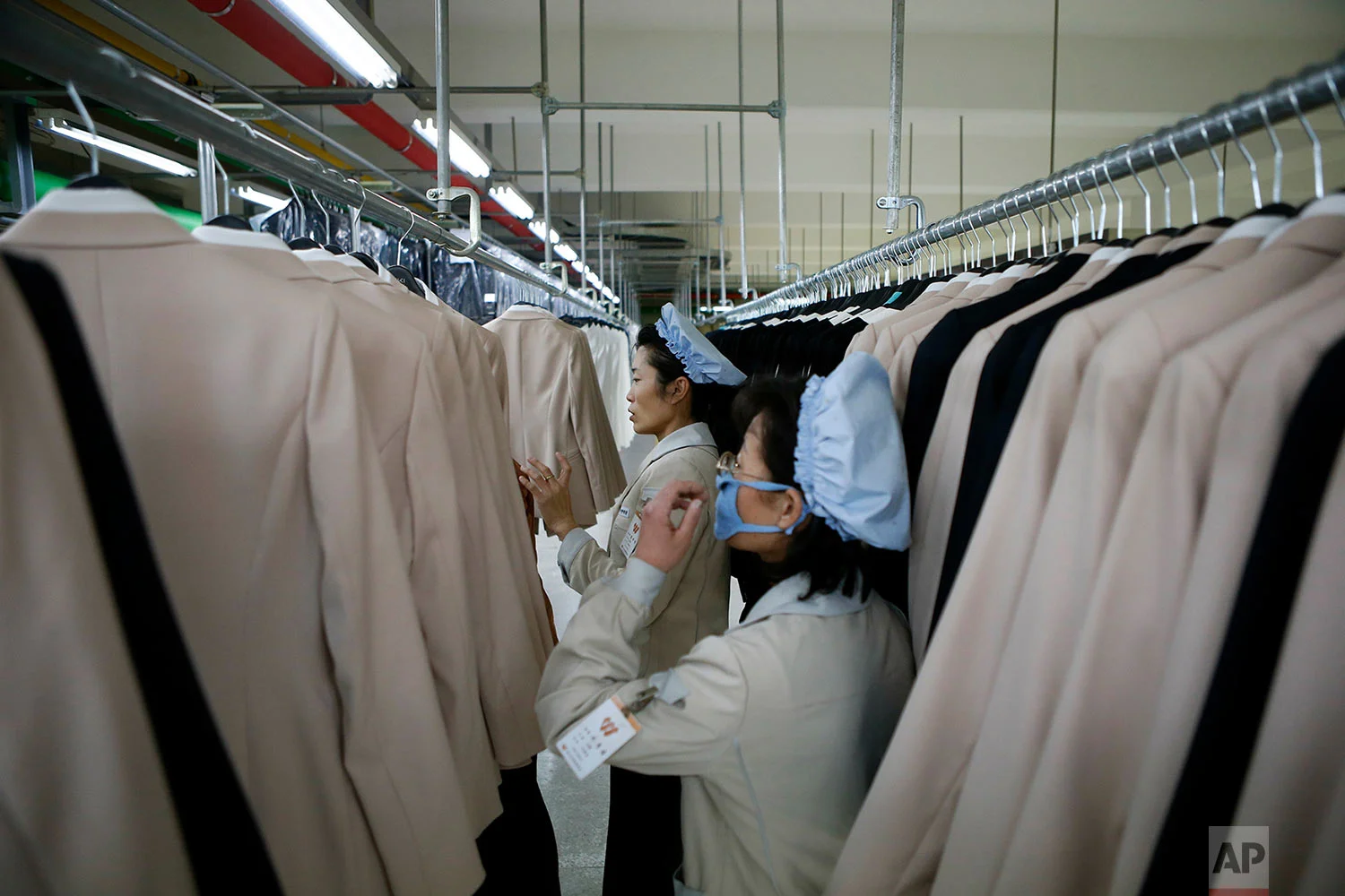 Workers check finished products at the factory of a South Korean-owned company at the jointly-run Kaesong Industrial Complex in Kaesong, North Korea, on Dec. 19, 2013. The Kaesong complex just north of the border is the last remaining inter-Korean rapprochement project. (Kim Hong-Ji/Pool Photo via AP)
