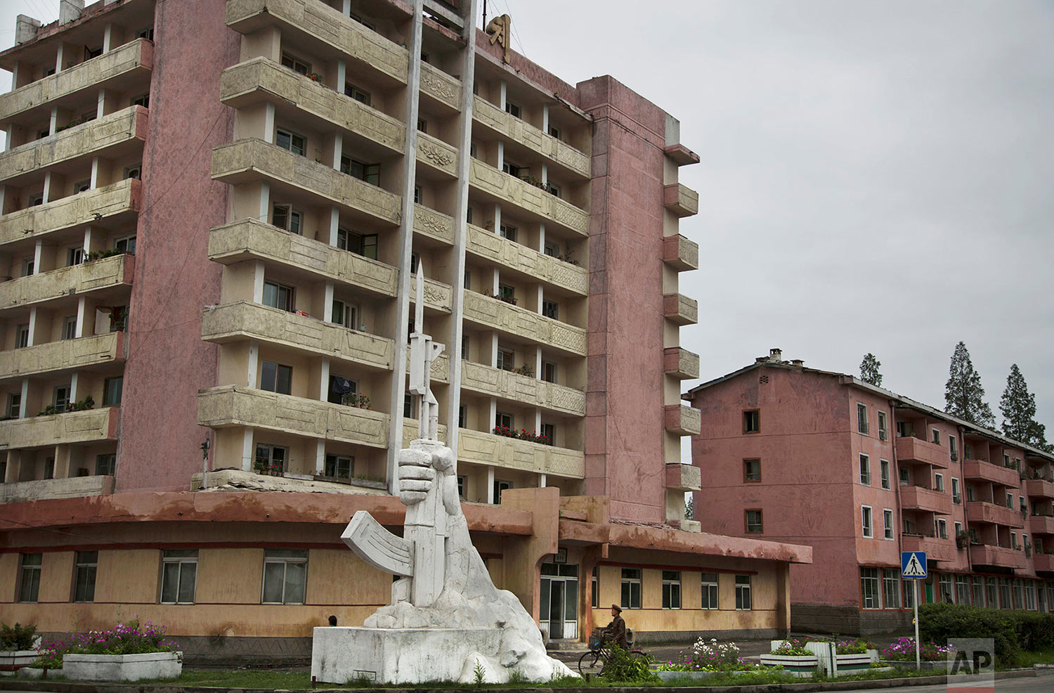 A monument of a fist holding a bayonetted Kalashnikov rifle stands on a roadside in North Korea's South Hamgyong province on June 21, 2014. (AP Photo/David Guttenfelder)