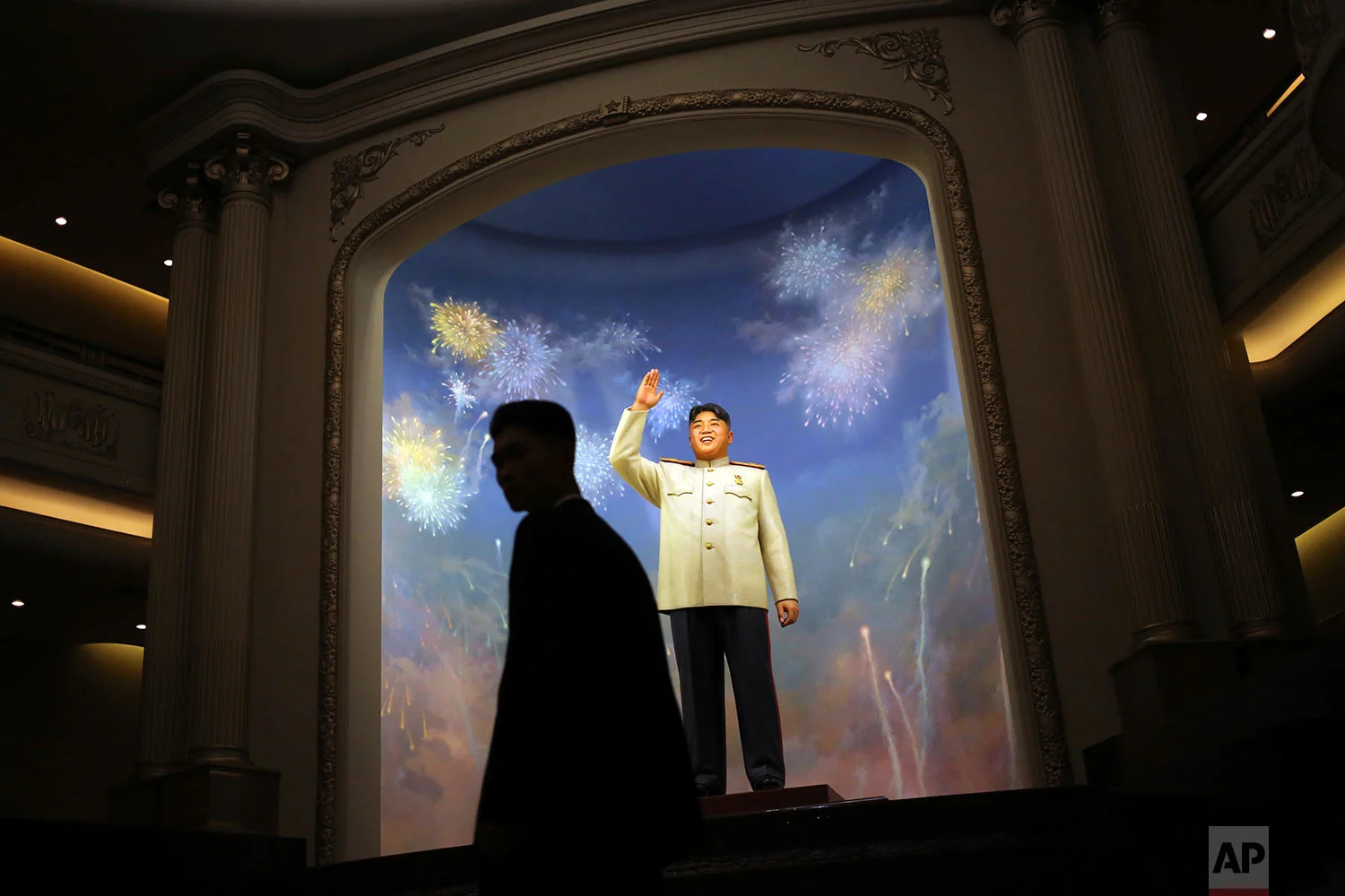 A man is silhouetted against a statue of the late North Korean leader Kim Il Sung at the newly opened Fatherland Liberation War Museum in Pyongyang, North Korea, during a celebration of the 60th anniversary of the Korean War armistice on June 27, 2013. (AP Photo/Wong Maye-E)