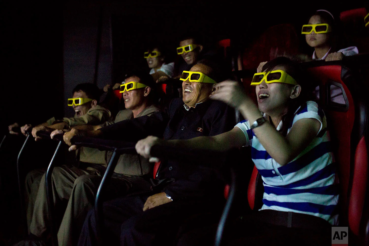 People watch a 3D movie on an amusement park ride at the Rungna People's Pleasure Park in Pyongyang, North Korea, on Sept. 22, 2013. (AP Photo/David Guttenfelder)