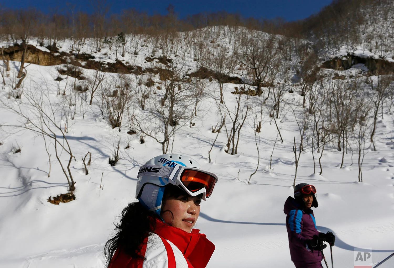 A man and woman ski at the Masik Pass ski resort, nestled deep in North Korea's eastern mountains, on Feb. 22, 2014. The resort has 10 ski runs, from beginning to advanced, a well-equipped rental shop, and a 250-room, eight-story hotel for foreigners alongside a 150-room hotel for Koreans. (AP Photo/Vincent Yu)