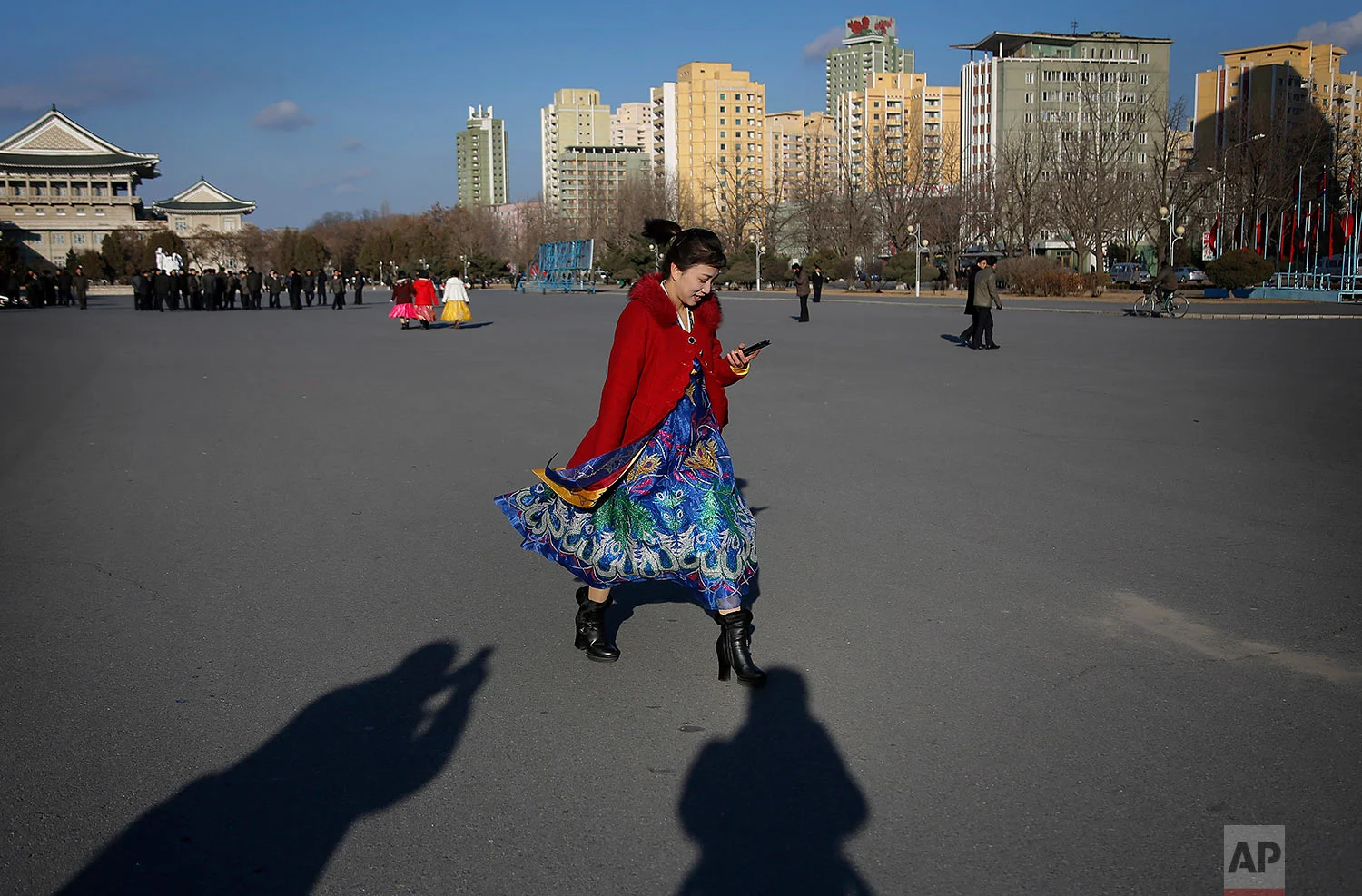 A woman in a traditional dress leaves the Pyongyang Indoor Stadium after attending a mass dance party celebrating the "Day of the Shining Star," or birthday of late North Korean leader Kim Jong Il, on Feb. 16, 2016, in Pyongyang, North Korea. (AP Photo/Wong Maye-E)