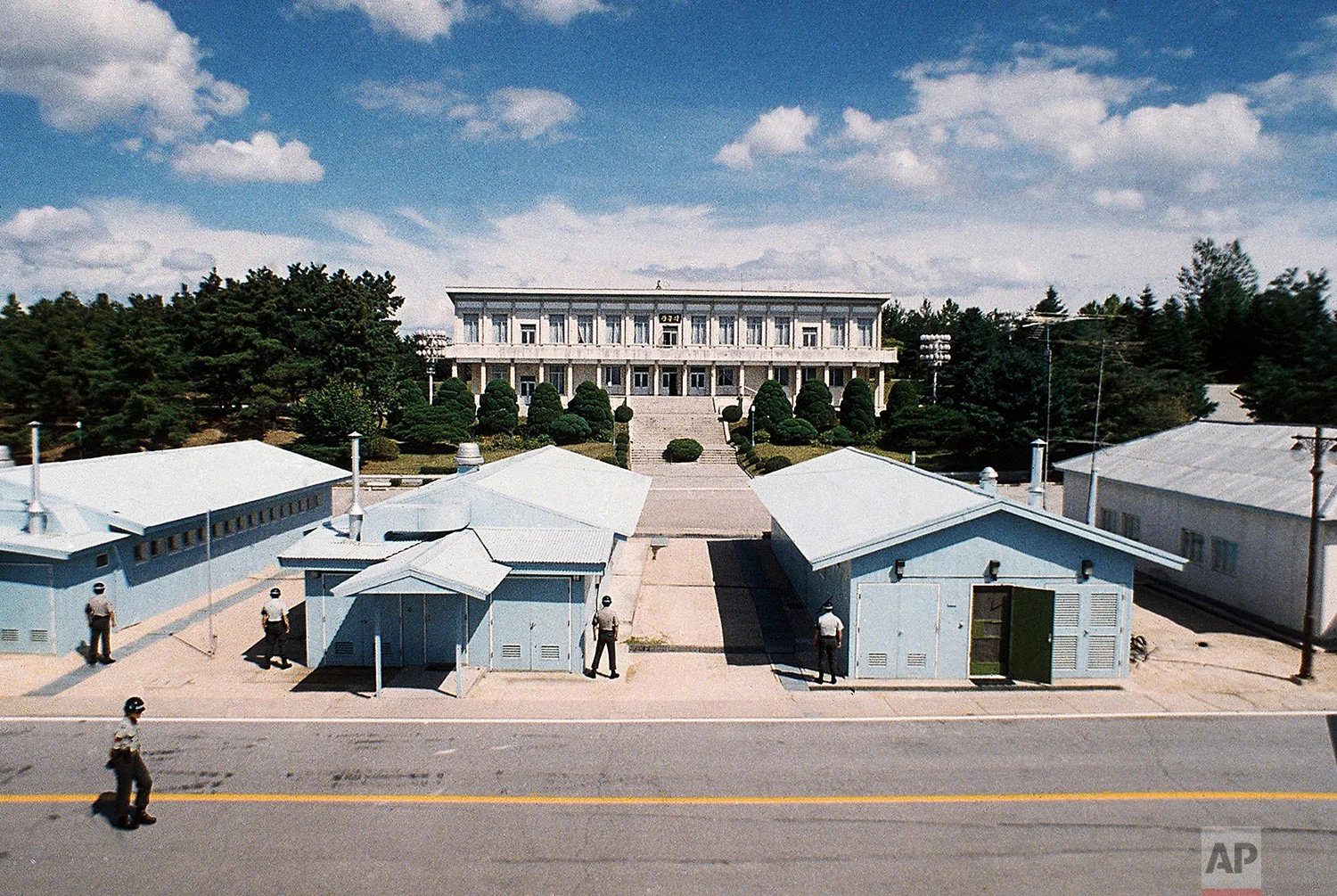 Soldiers stand guard at the area known as Conference Row in Panmunjom, Korea, with North Korea's Panmun-gak building in the background in 1988. (AP Photo)