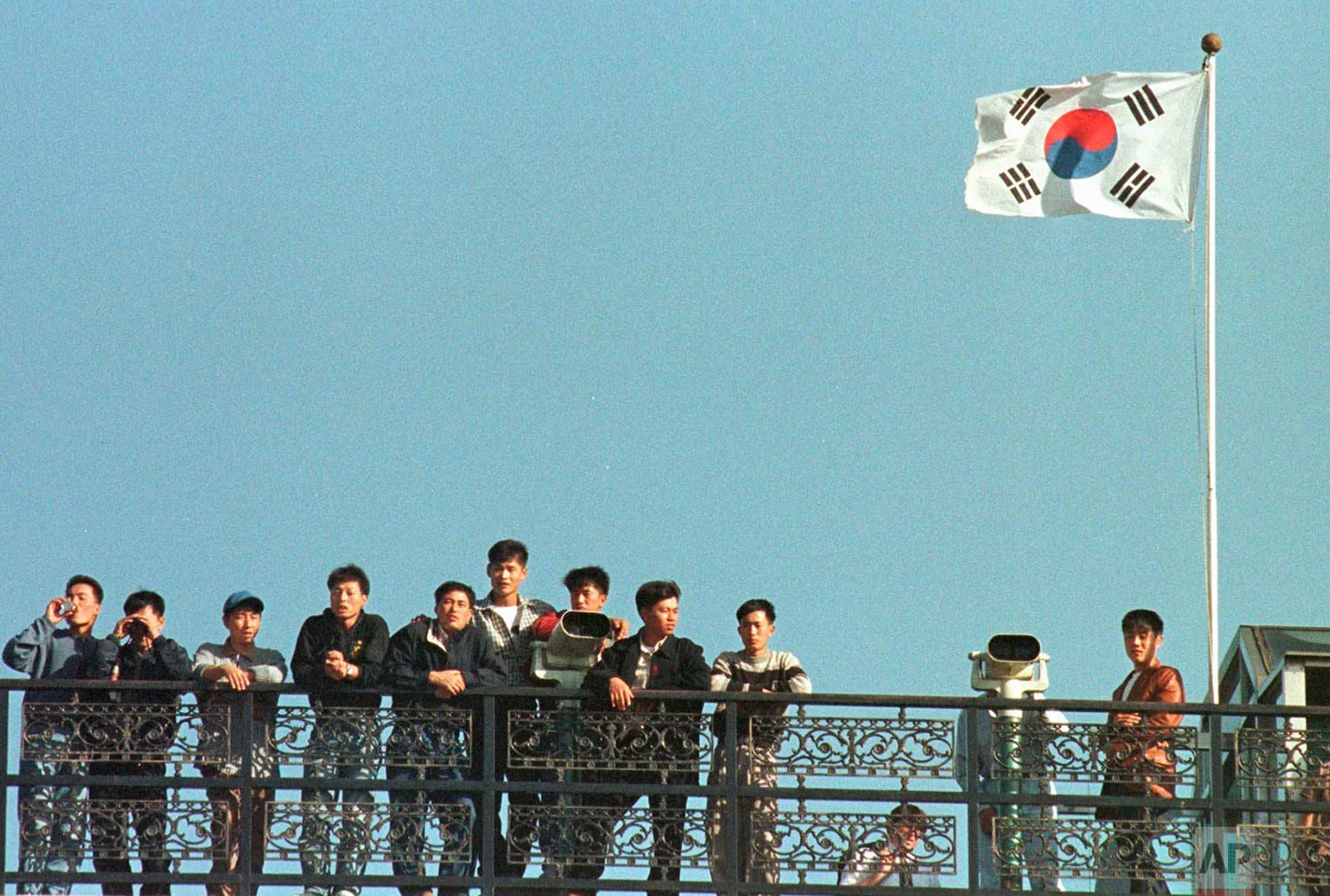 South Korean students look across the Demilitarized Zone between the two Koreas at the guard post of Imjingak, north of Seoul, Friday, Oct. 17, 1997. Earlier that day, North Korean soldiers crossed into the southern half of the buffer zone, seizing two South Korean farmers in a rice field and taking them back to the northern side. The farmers were returned soon afterward. (AP Photo/Yun Jai-hyoung)