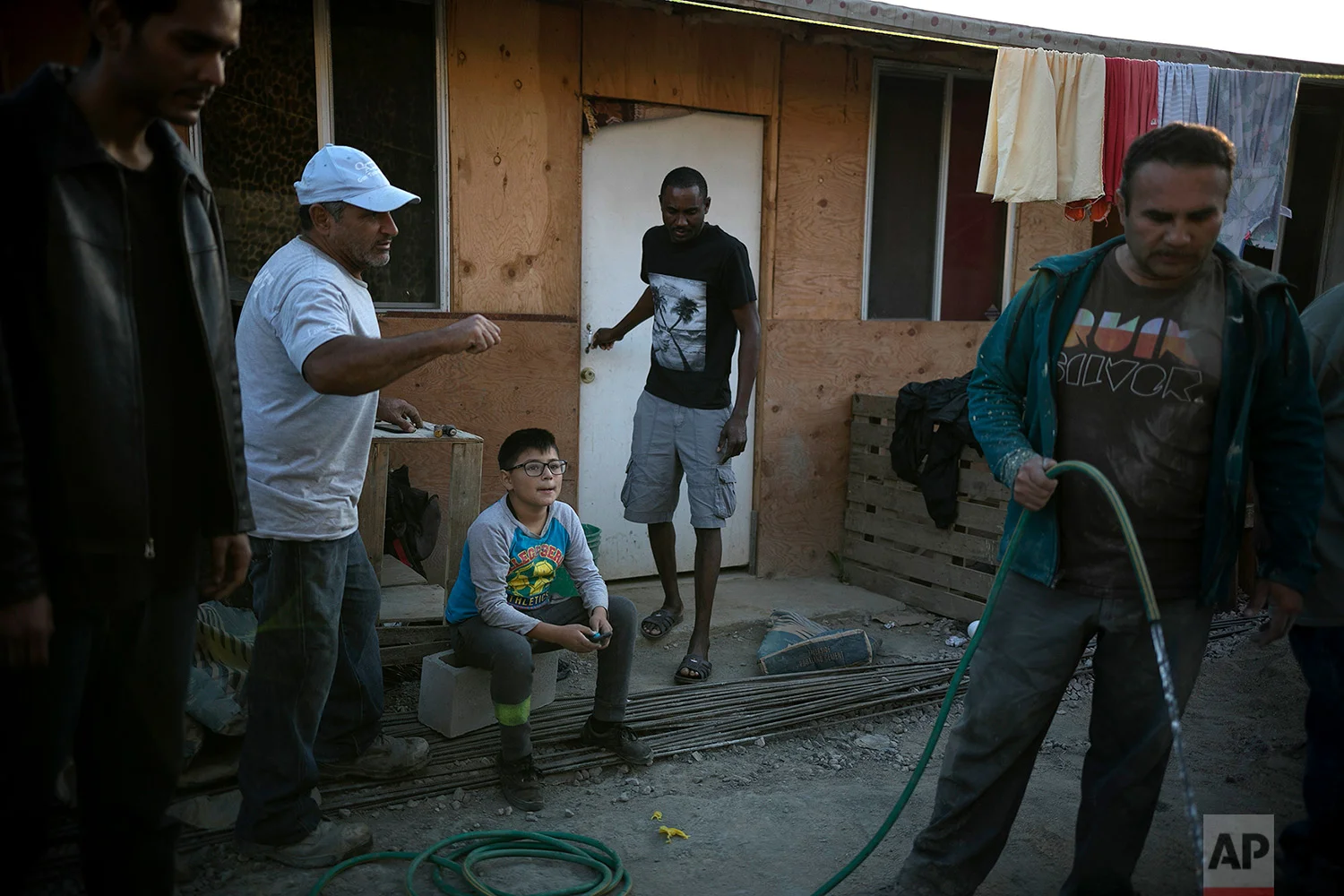A resident of Little Haiti leaves a house built by a pastor and volunteers in Tijuana, Mexico, May 9, 2018. (AP Photo/Emilio Espejel)