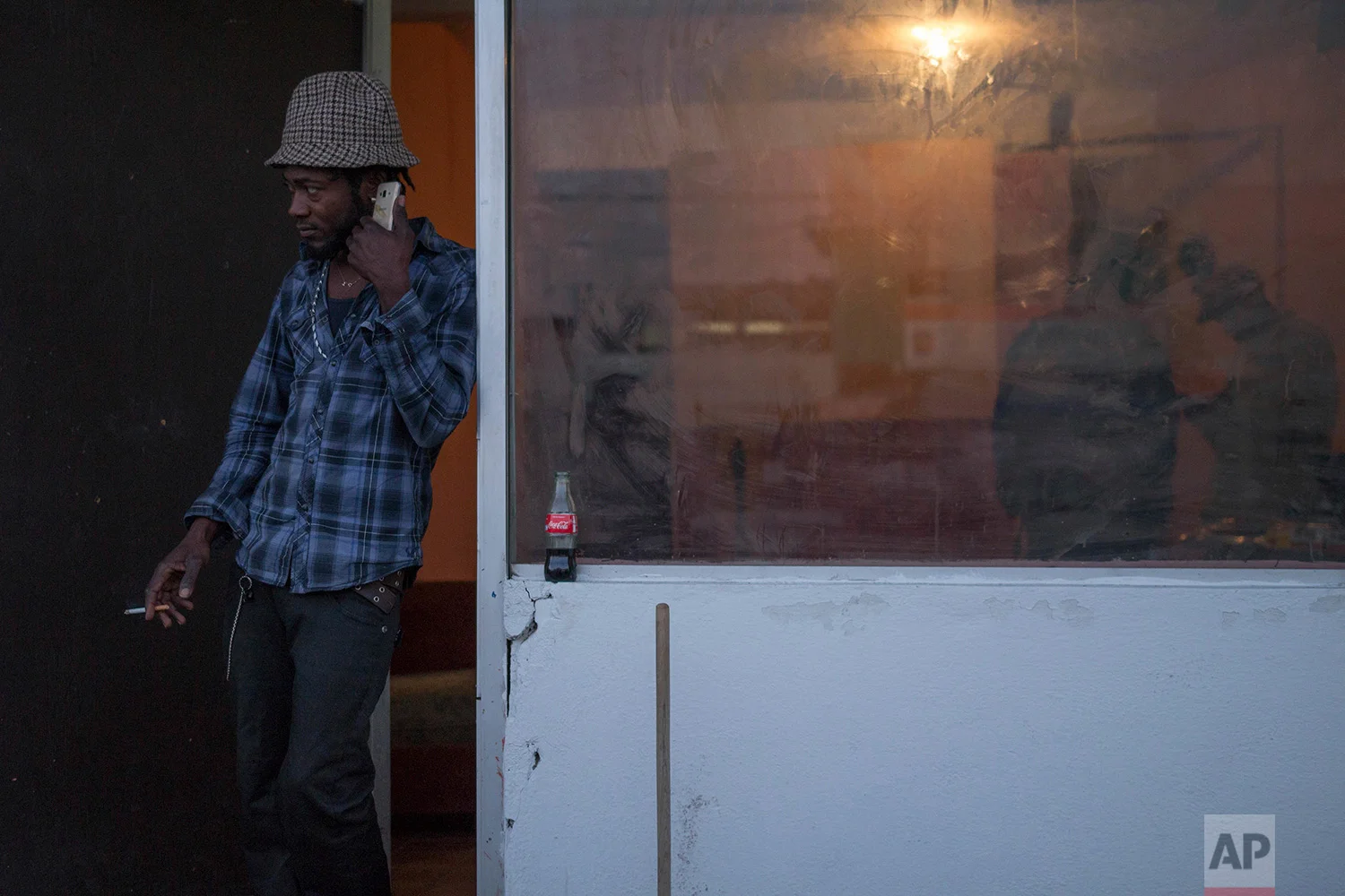 A man stands in the doorway of a cultural center and barbershop in Tijuana, Mexico, February 25, 2018. (AP Photo/Emilio Espejel)
