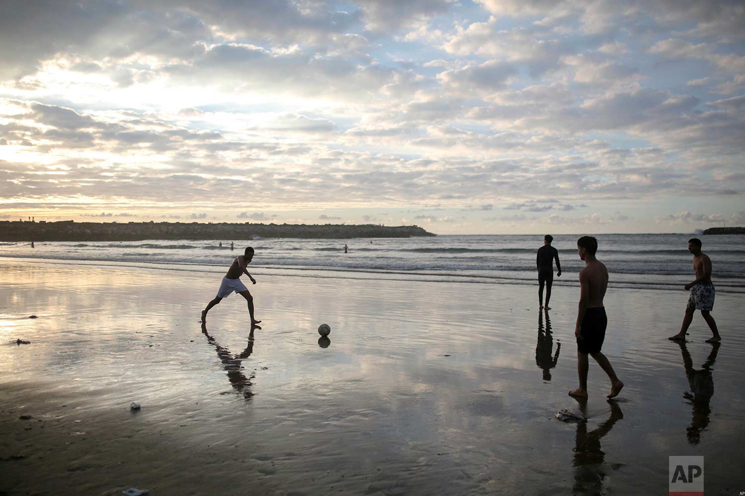 In this photo taken on Saturday, June 9, 2018, boys are silhouetted against the sunset light as they play football on the beach, minutes before breaking their fast in the holy month of Ramadan, in Rabat, Morocco. (AP Photo/Mosa'ab Elshamy) 