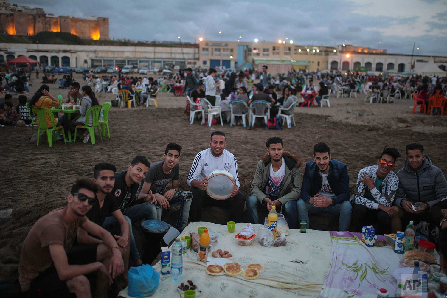  Young men pose for a photo as they gather to break their fast on the beach in the holy month of Ramadan, in Rabat, Morocco, Saturday, June 9, 2018. (AP Photo/Mosa'ab Elshamy) 