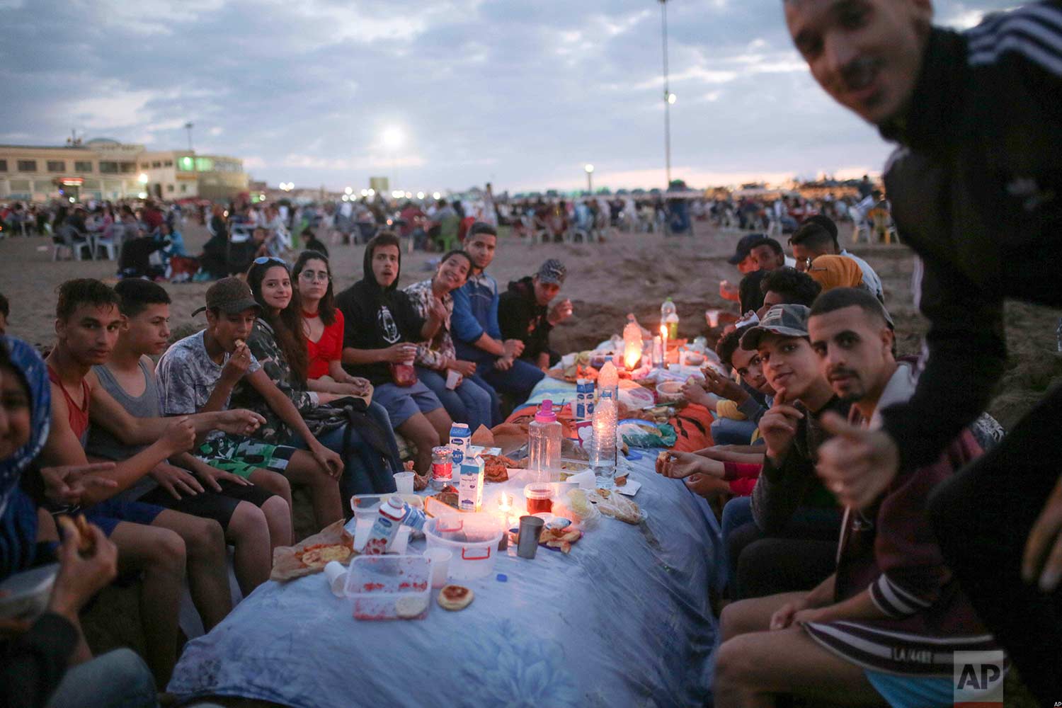  Friends pose for a photo as they prepare to break their fast on the beach, in the holy month of Ramadan, Rabat, Morocco, Saturday, June 9, 2018. (AP Photo/Mosa'ab Elshamy) 