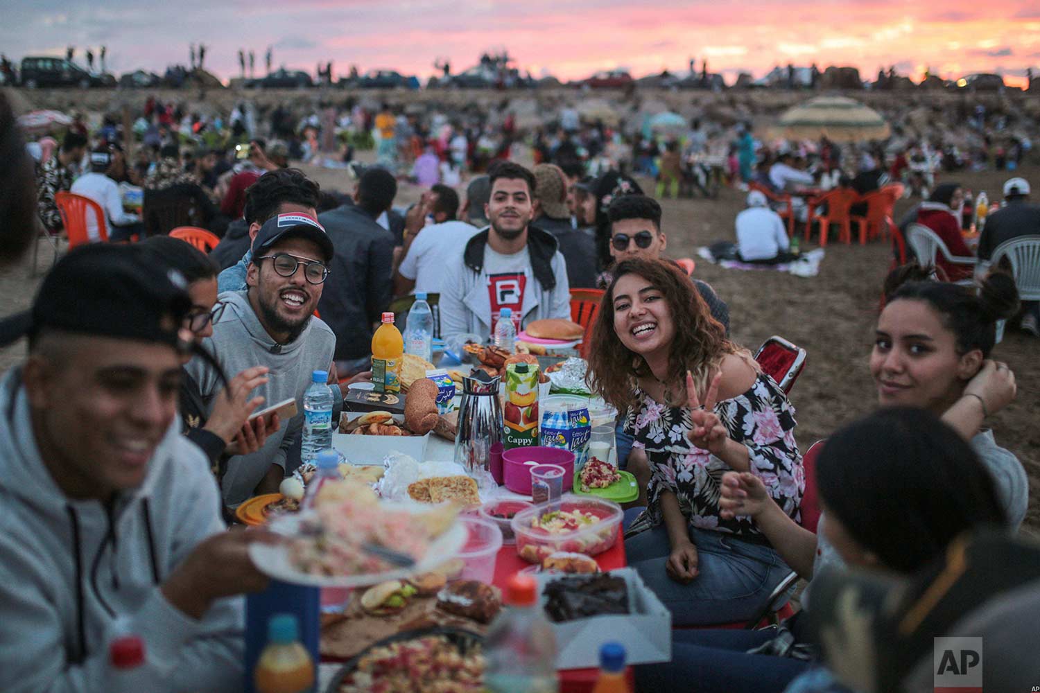 Friends pose for a photo as they prepare to break their fast on the beach in the holy month of Ramadan, on Rabat beach, Morocco, Saturday, June 9, 2018. (AP Photo/Mosa'ab Elshamy) 