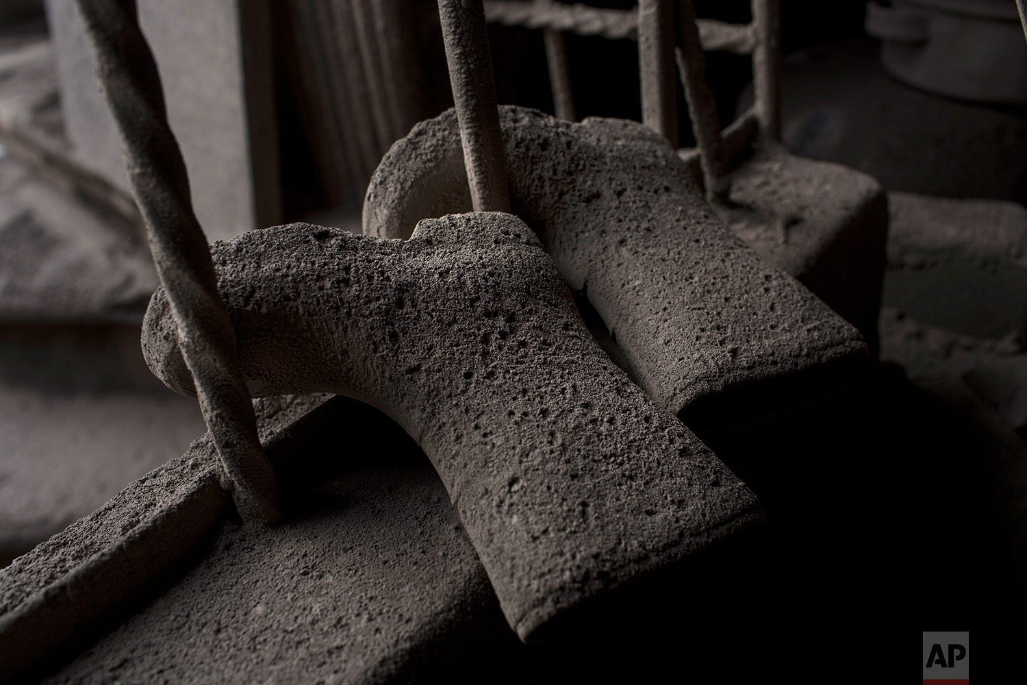  This June 9, 2018 photo shows a child's pair of rain boots coated with volcanic ash spewed by the Volcan de Fuego or Volcano of Fire, in San Miguel Los Lotes, Guatemala. (AP Photo/Rodrigo Abd) 