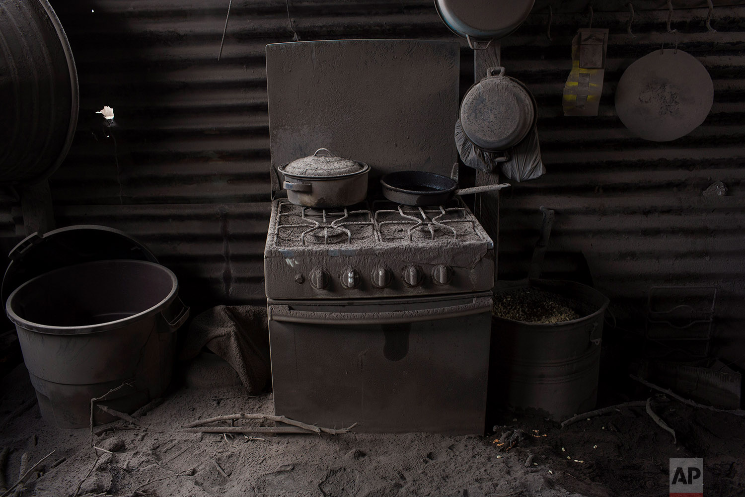  This June 11, 2018 photo shows a kitchen blanketed in volcanic ash spewed by the Volcan de Fuego or Volcano of Fire, in San Miguel Los Lotes, Guatemala. (AP Photo/Rodrigo Abd) 