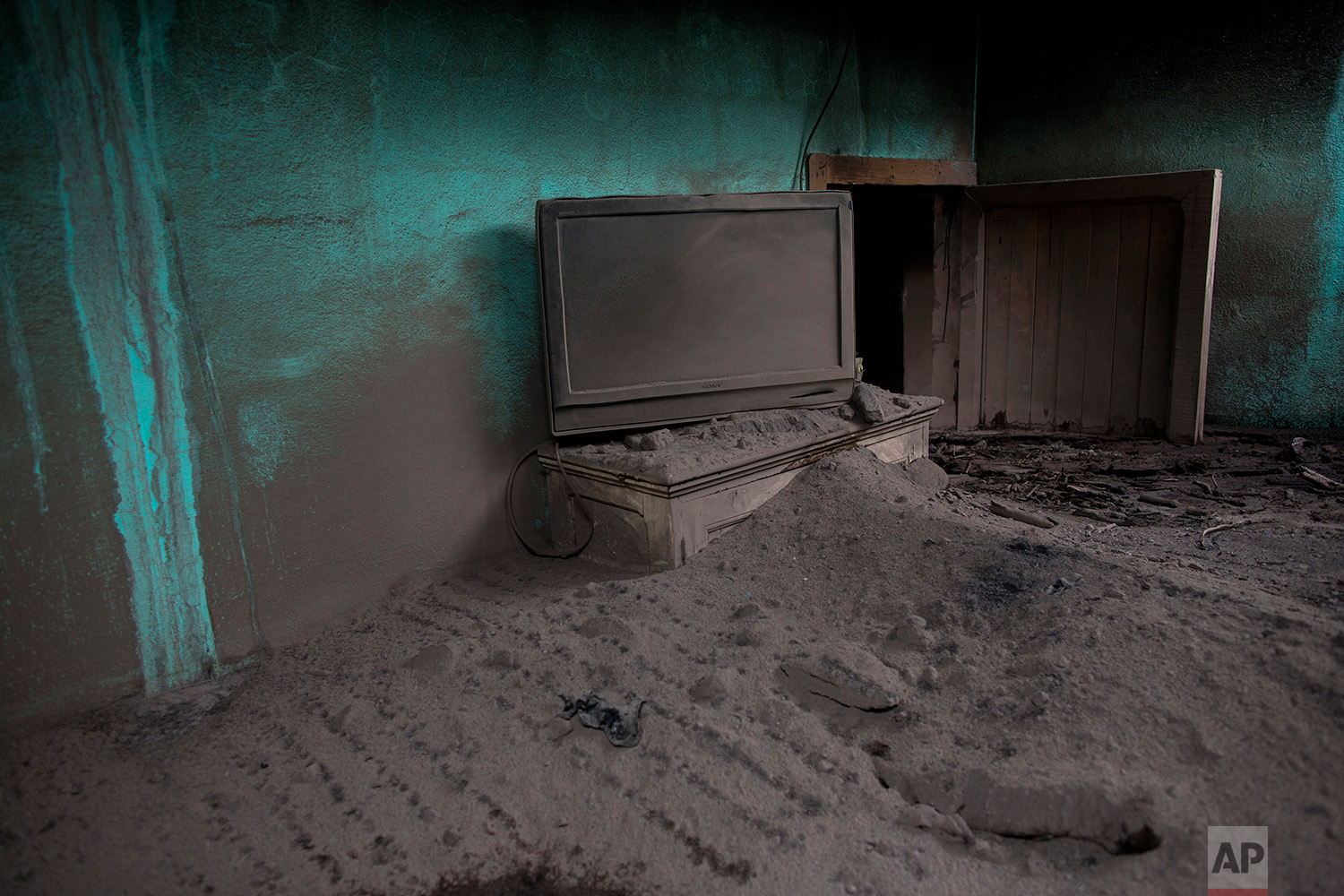  This June 8, 2018 photo shows a living room engulfed in volcanic ash spewed by the Volcan de Fuego or Volcano of Fire, in San Miguel Los Lotes, Guatemala. (AP Photo/Rodrigo Abd) 