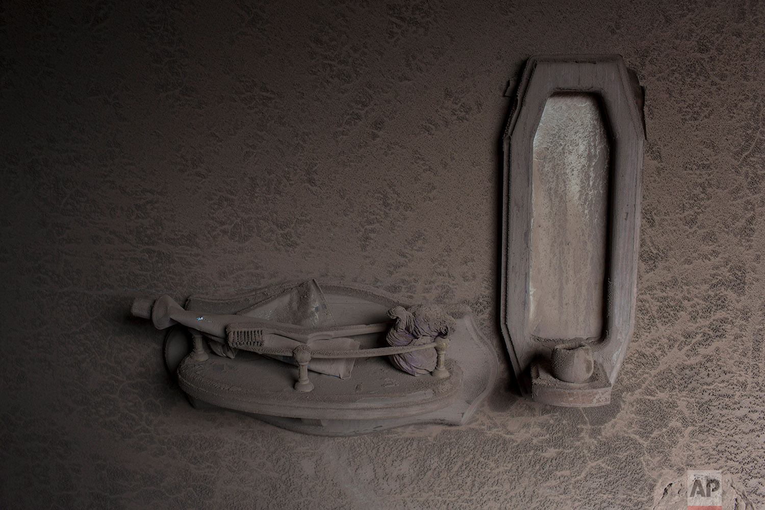  This June 8, 2018 photo shows a tube of toothpaste and toothbrush coated  with volcanic ash spewed by the Volcan de Fuego or Volcano of Fire, in a bathroom in San Miguel Los Lotes, Guatemala. (AP Photo/Rodrigo Abd) 