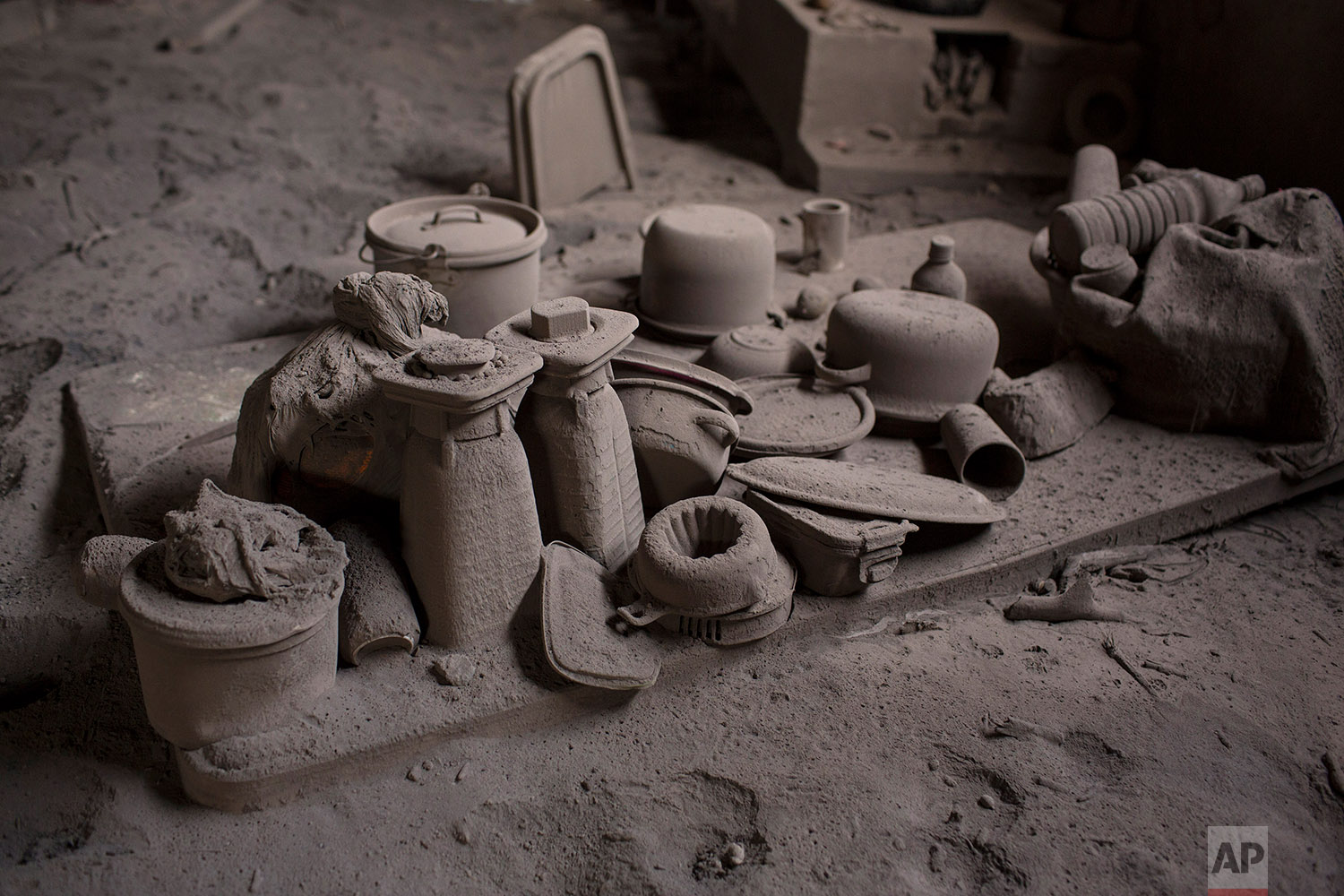  This June 9, 2018 photo shows kitchen wares coated with volcanic ash spewed by the Volcan de Fuego or Volcano of Fire, in San Miguel Los Lotes, Guatemala. (AP Photo/Rodrigo Abd) 