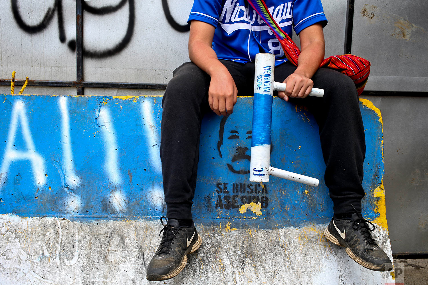  In this June 6, 2018 photo, an anti-government protester holds a handmade mortar at a roadblock in Ticuantepe, Nicaragua. (AP Photo/Esteban Felix) 