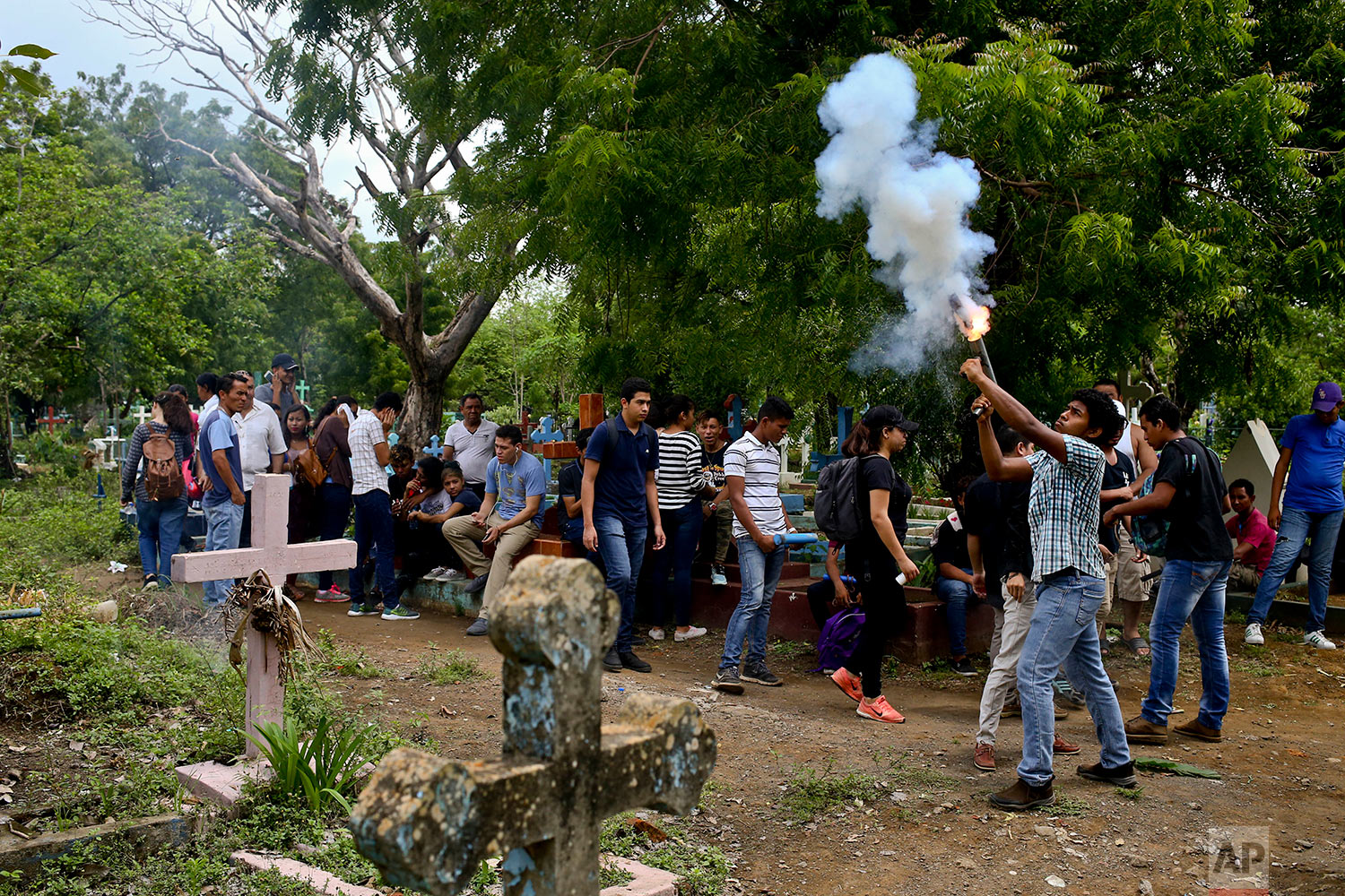  In this May 25, 2018 photo, a youth fires a handmade mortar during the burial of Manuel de Jesus Chavez at the cemetery in Leon, Nicaragua. Chavez, 38, died during clashes with police as anti-government protesters blocked the Panamerican Highway. (A