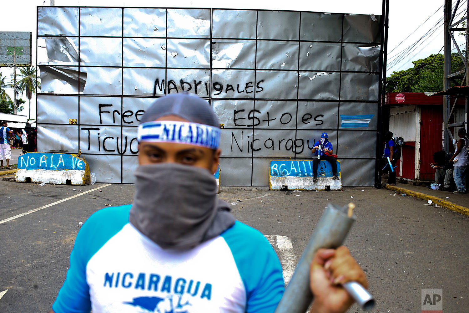  In this June 6, 2018 photo, an anti-government protester poses for a picture holding a homemade mortar at a roadblock set up by protesters in Ticuantepe, Nicaragua. (AP Photo/Esteban Felix) 