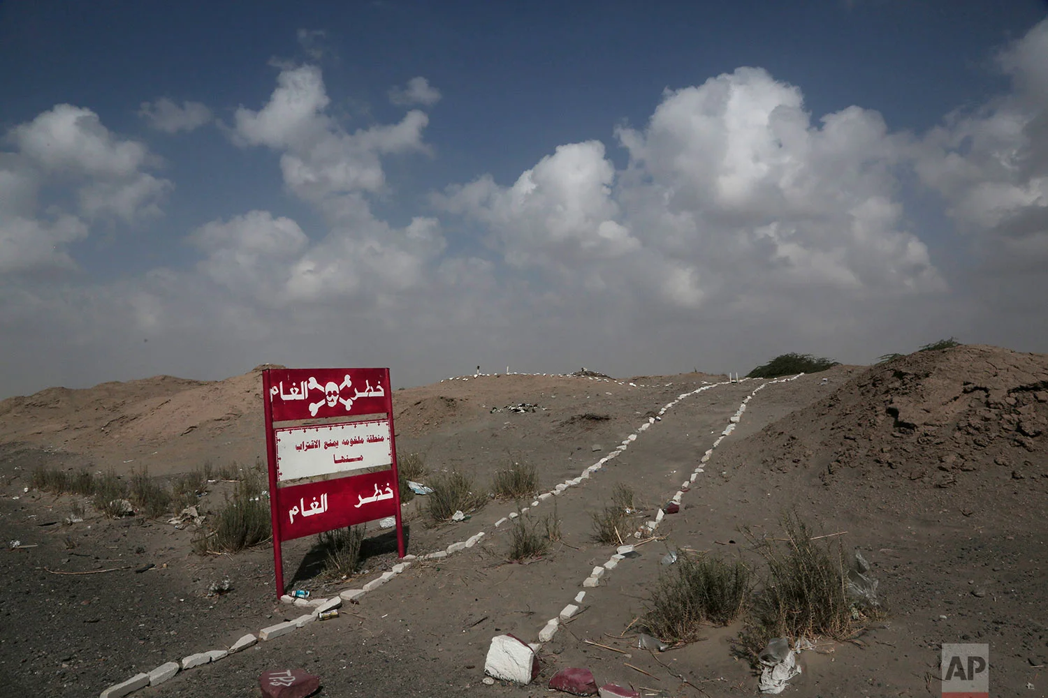 A sign with Arabic that reads, "danger mines, danger mines" on the highway from Abyan to Aden in Yemen. (AP Photo/Nariman El-Mofty)