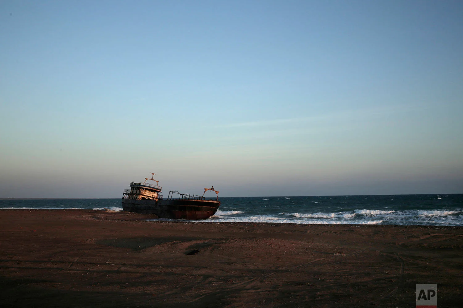 A ship wreck abandoned on the shore from Mocha to Aden in Yemen. On the beach, old pleasure venues also lie empty, broken and deserted due to the civil war here. (AP Photo/Nariman El-Mofty)
