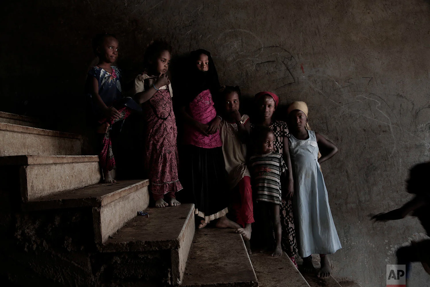 Displaced girls pose for a photograph inside a school turned into a camp for displaced persons in Khanfar, Abyan, Yemen. (AP Photo/Nariman El-Mofty)