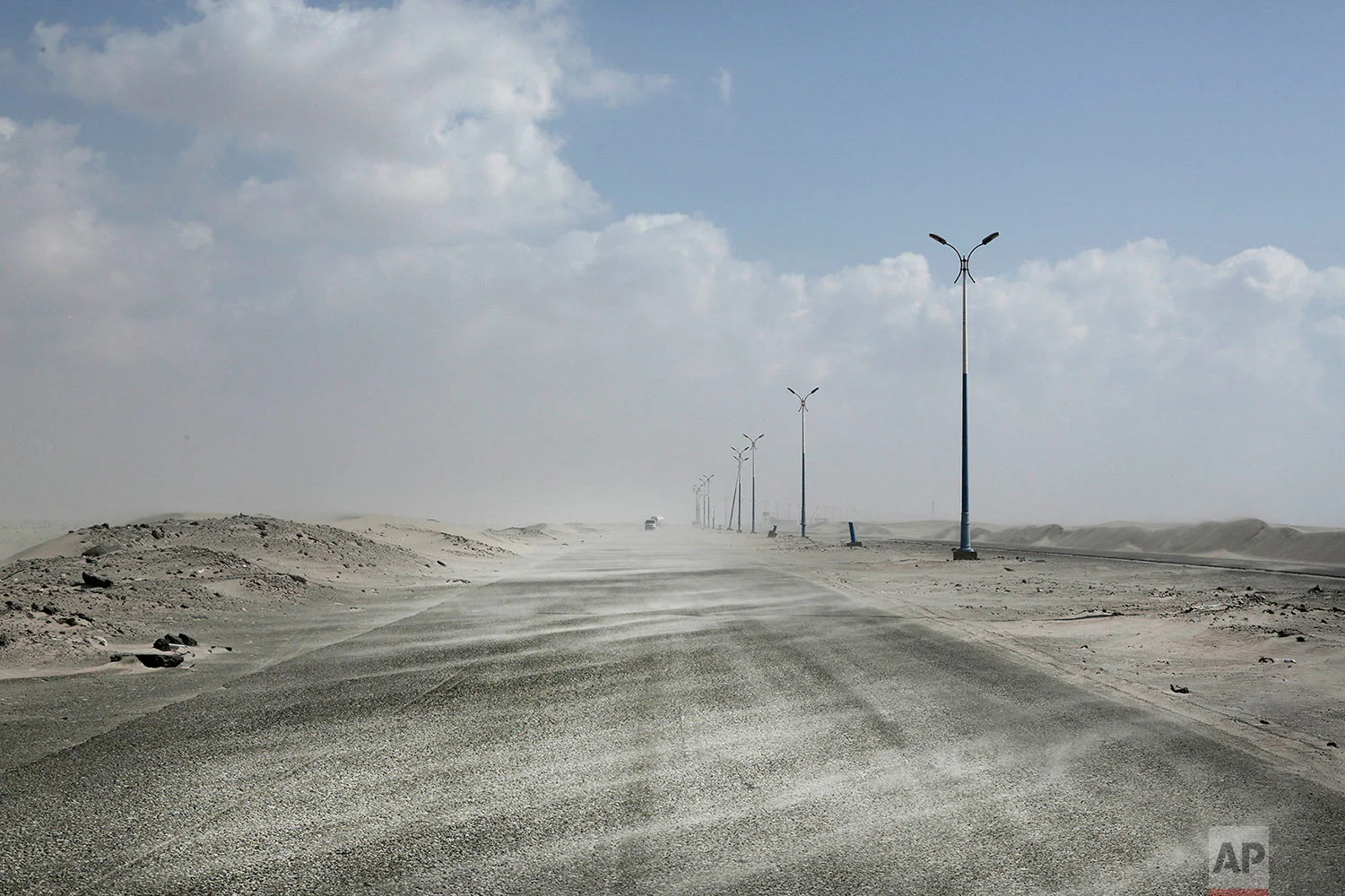 Sand drifting over an empty highway from Abyan to Aden in Yemen. (AP Photo/Nariman El-Mofty)