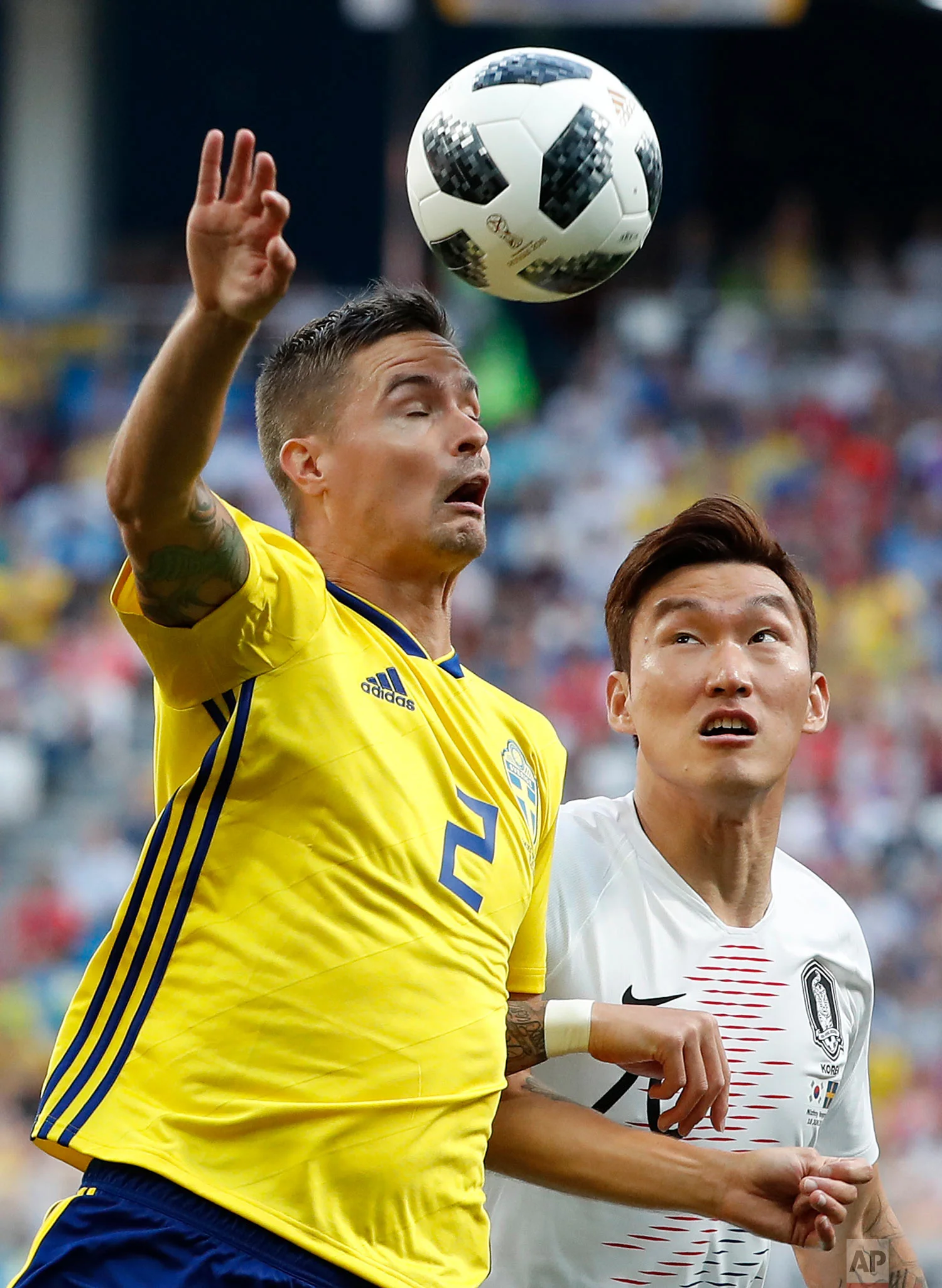 Sweden's Mikael Lustig, left, and South Korea's Jang Hyun-soo battle for the ball during the group F match between Sweden and South Korea at the 2018 soccer World Cup in the Nizhny Novgorod stadium in Nizhny Novgorod, Russia, Monday, June 18, 2018. (AP Photo/Pavel Golovkin)