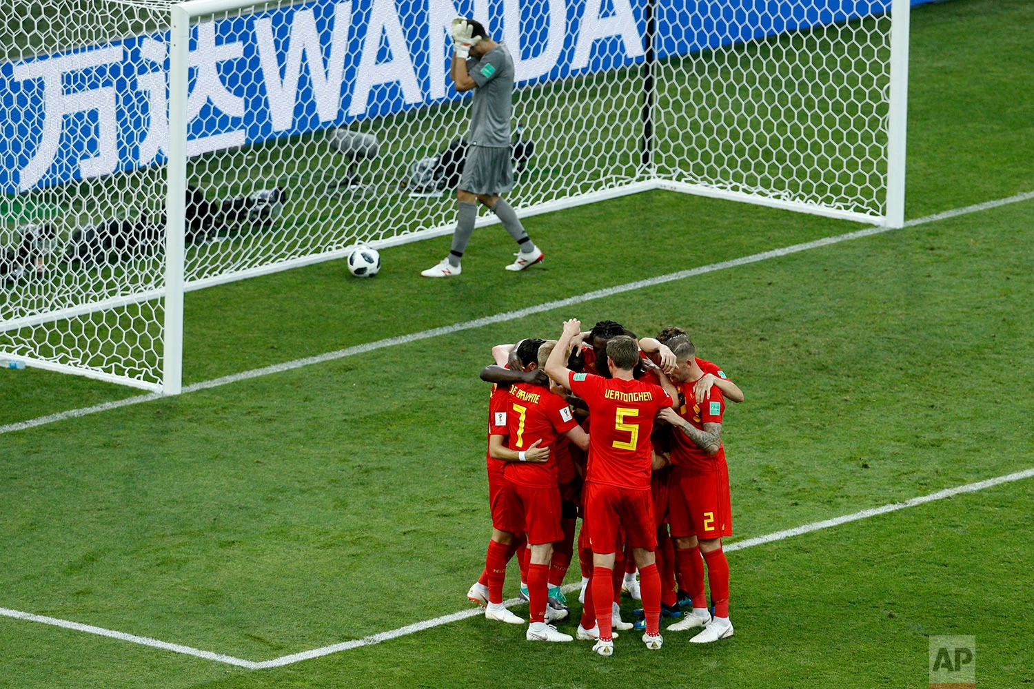 Belgium players celebrate after Romelo Lukaku scored their side's second goal as Panama goalkeeper Jaime Penedo, top, picks the ball inside the goal during the group G match between Belgium and Panama at the 2018 soccer World Cup in the Fisht Stadium in Sochi, Russia, Monday, June 18, 2018. (AP Photo/Victor R. Caivano)