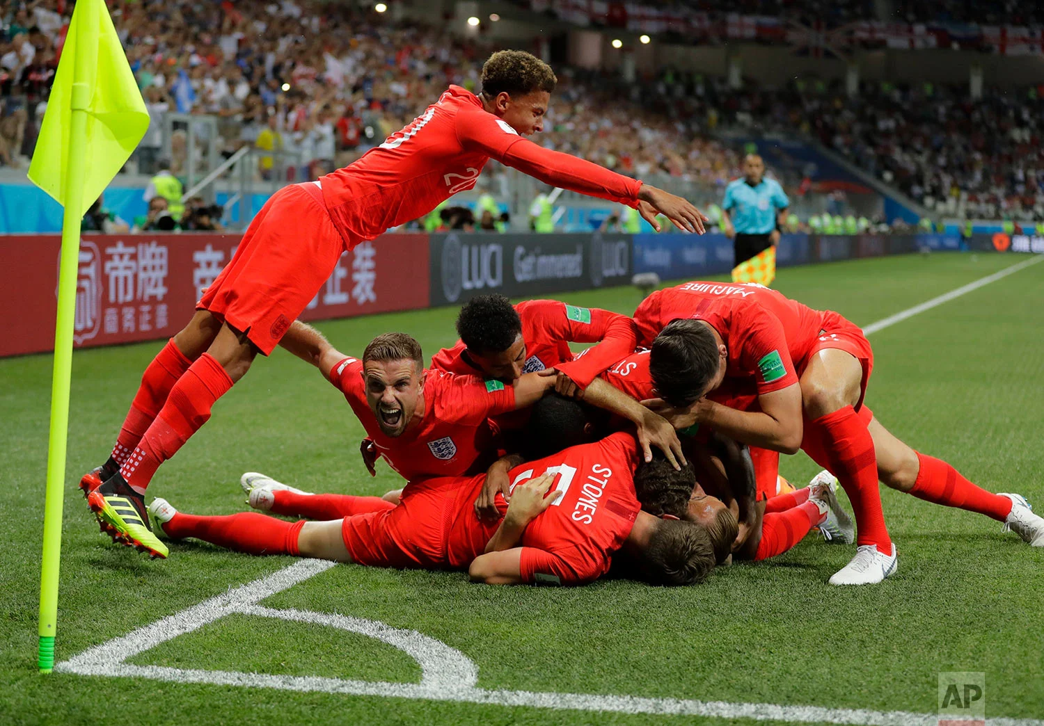 England's team celebrate after scoring their side's opening goal against Tunisia during the group G match between Tunisia and England at the 2018 soccer World Cup in the Volgograd Arena in Volgograd, Russia, Monday, June 18, 2018. (AP Photo/Sergei G