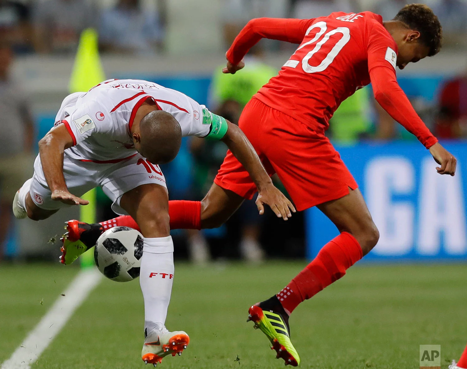 Tunisia's captain Wahbi Khazri, left, and England's Dele Alli compete for the ball during a group G match at the 2018 soccer World Cup in the Volgograd Arena in Volgograd, Russia, Monday, June 18, 2018. (AP Photo/Alastair Grant)