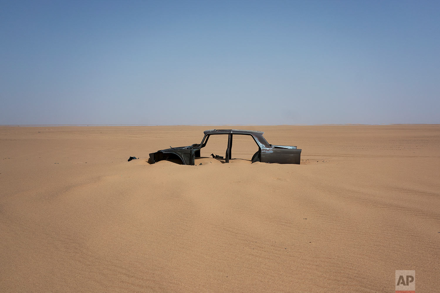  The frame of an abandoned Peugeot 404 rests in Niger's Tenere desert region of the south central Sahara on June 3, 2018. (AP Photo/Jerome Delay) 