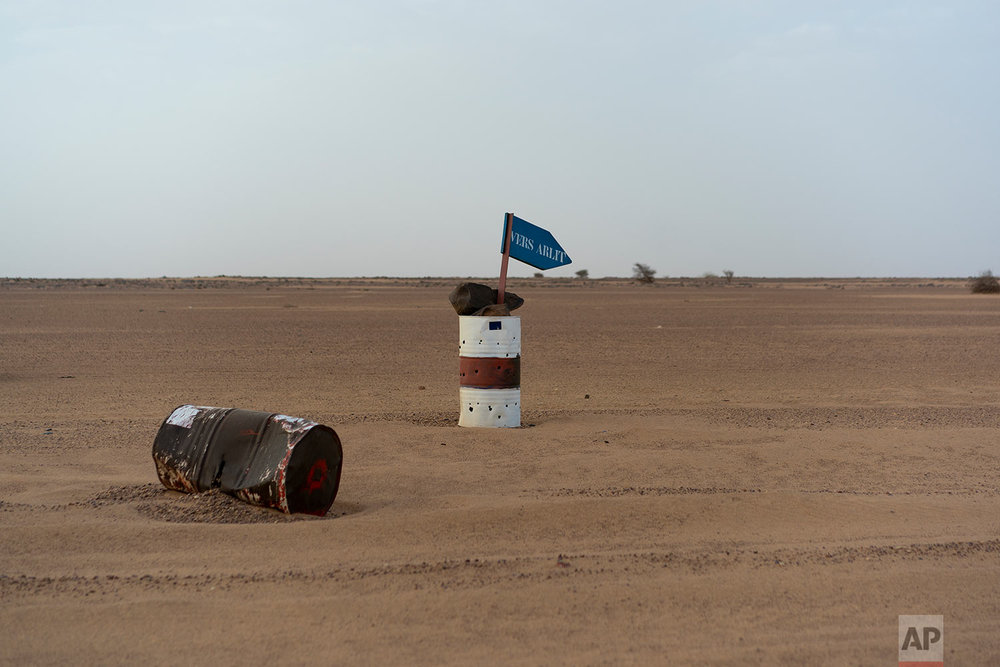  A bullet ridden paired barrel indicates the direction of Arlit in Niger's Tenere desert region of the south central Sahara on June 3, 2018. (AP Photo/Jerome Delay) 