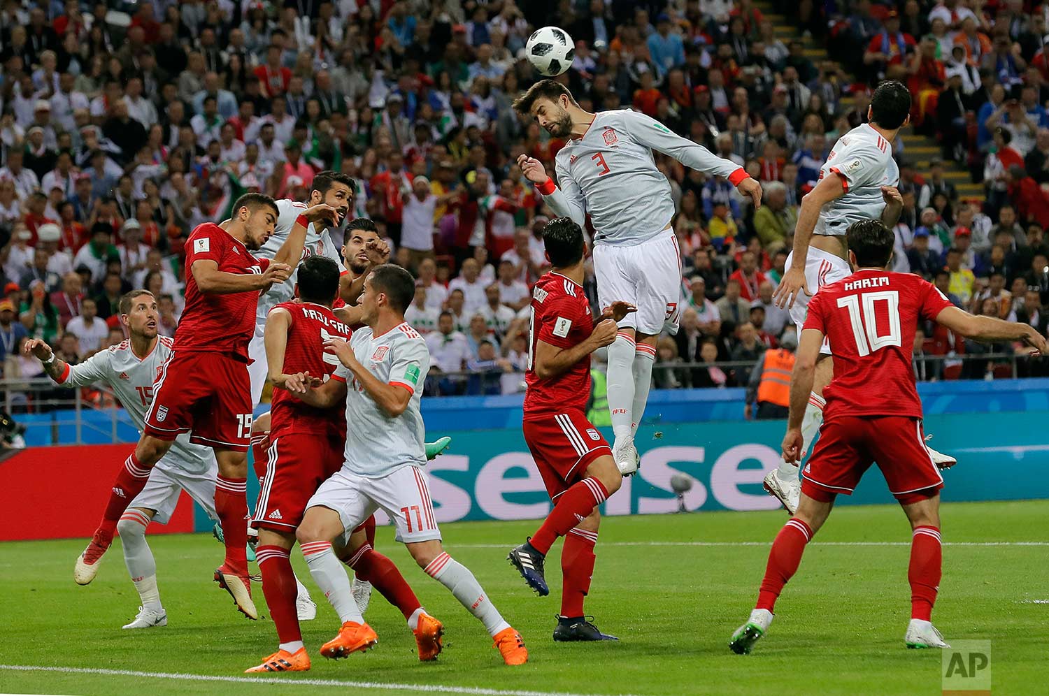  Spain's Gerard Pique, center, jumps for a header during the group B match between Iran and Spain at the 2018 soccer World Cup in the Kazan Arena in Kazan, Russia, Wednesday, June 20, 2018. (AP Photo/Manu Fernandez) 